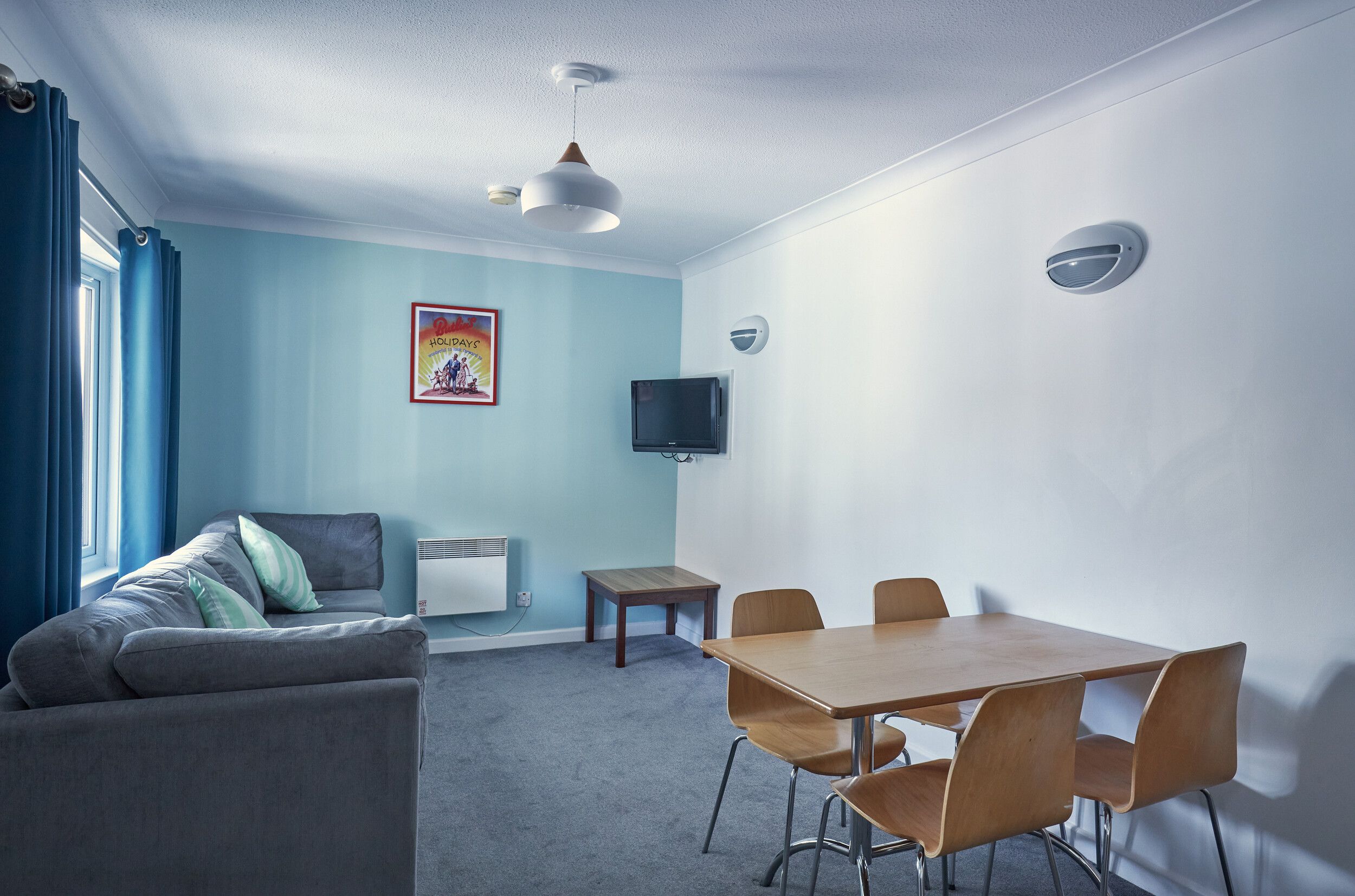 A living room with television and a coffee table in our Comfort Apartments at Bognor Regis.