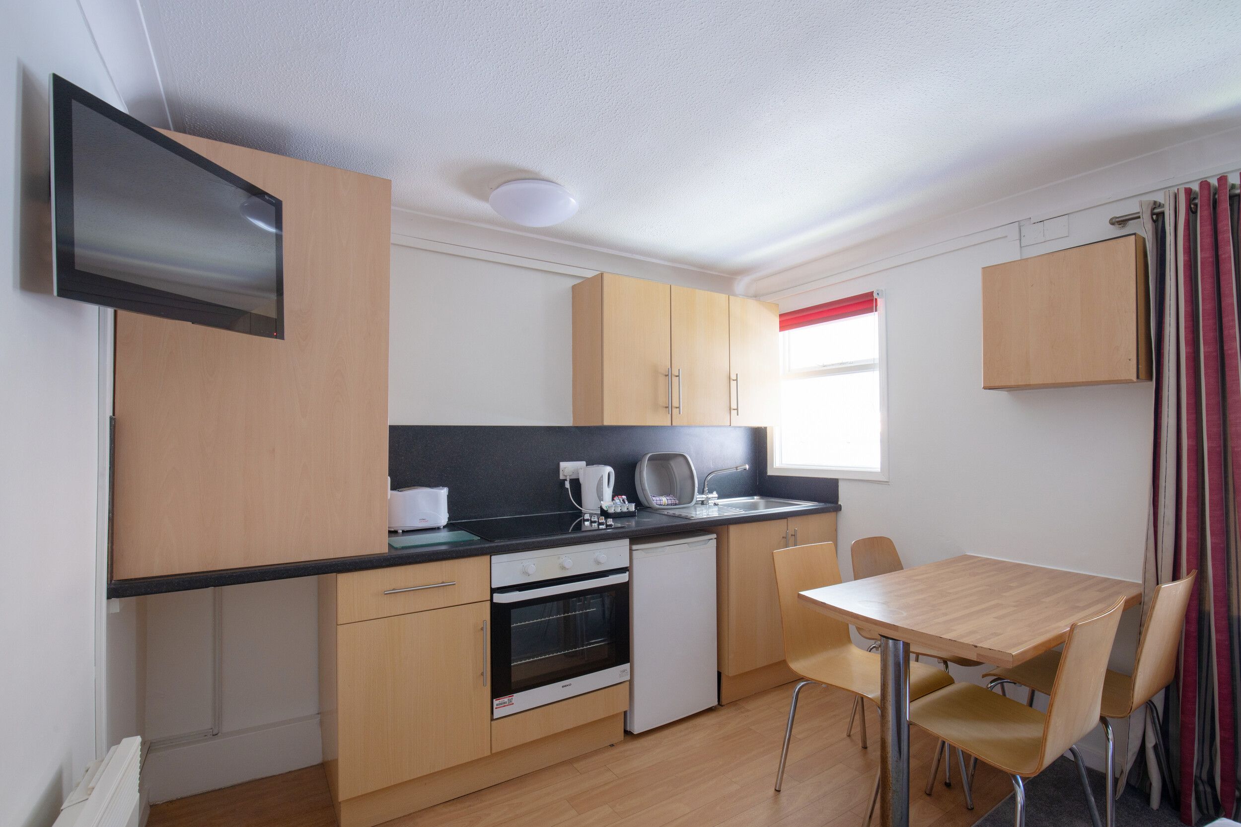 A kitchen with dining area in our Standard Apartments at Bognor Regis.