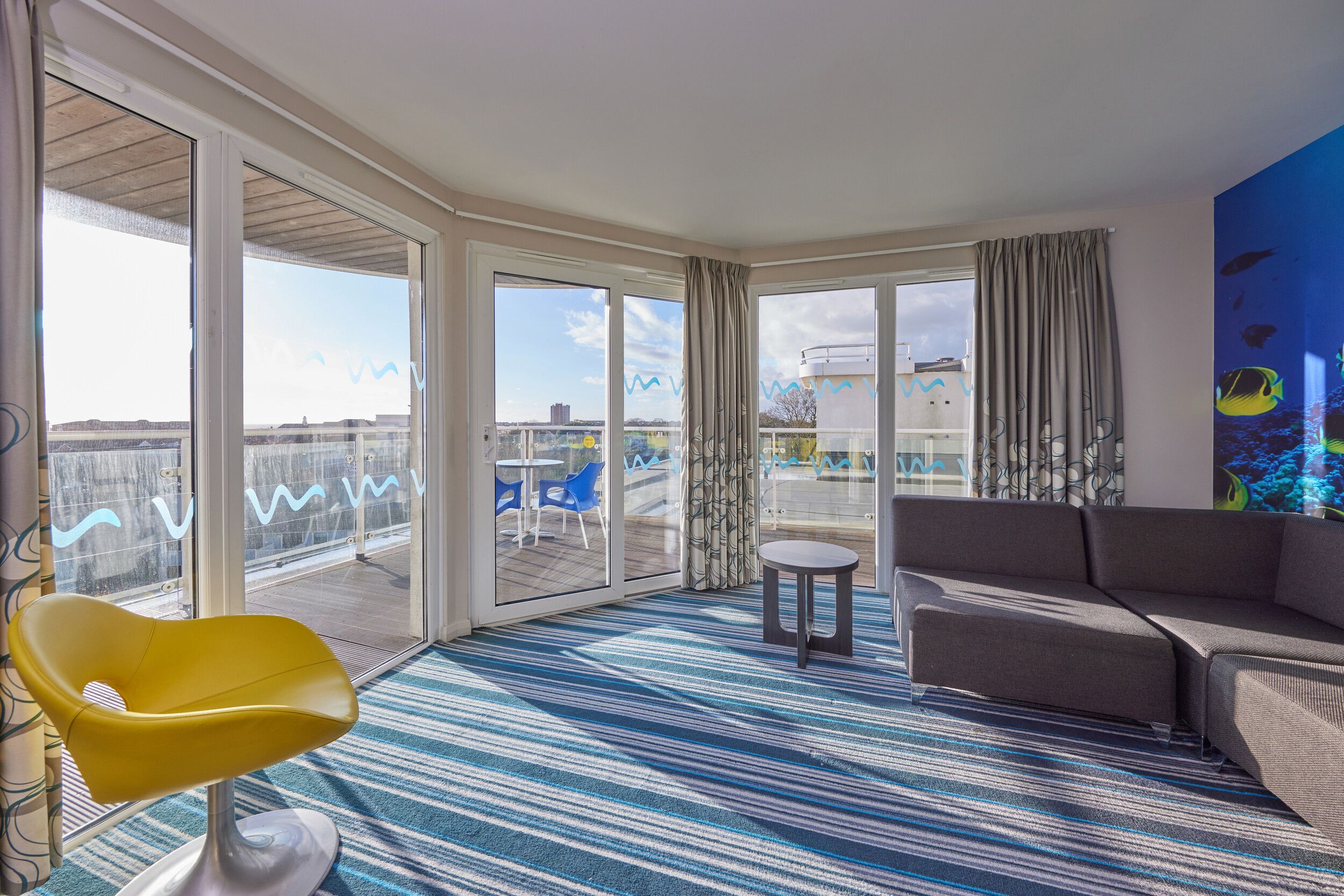 A living room with sofas and coffee table in our Wave Hotel Apartments at Bognor Regis.