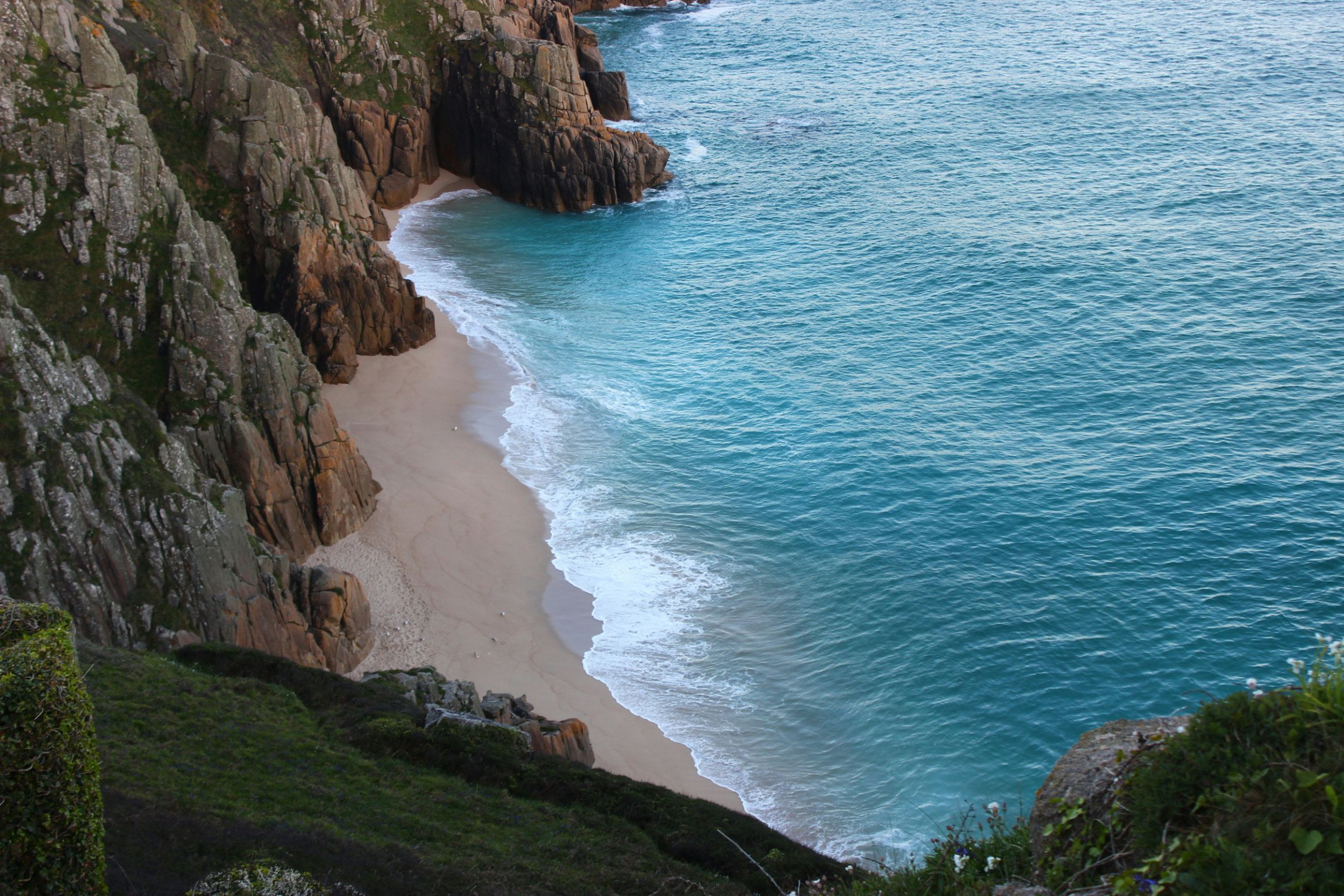 A view from a cliff down to the beach on the South West Coast Path