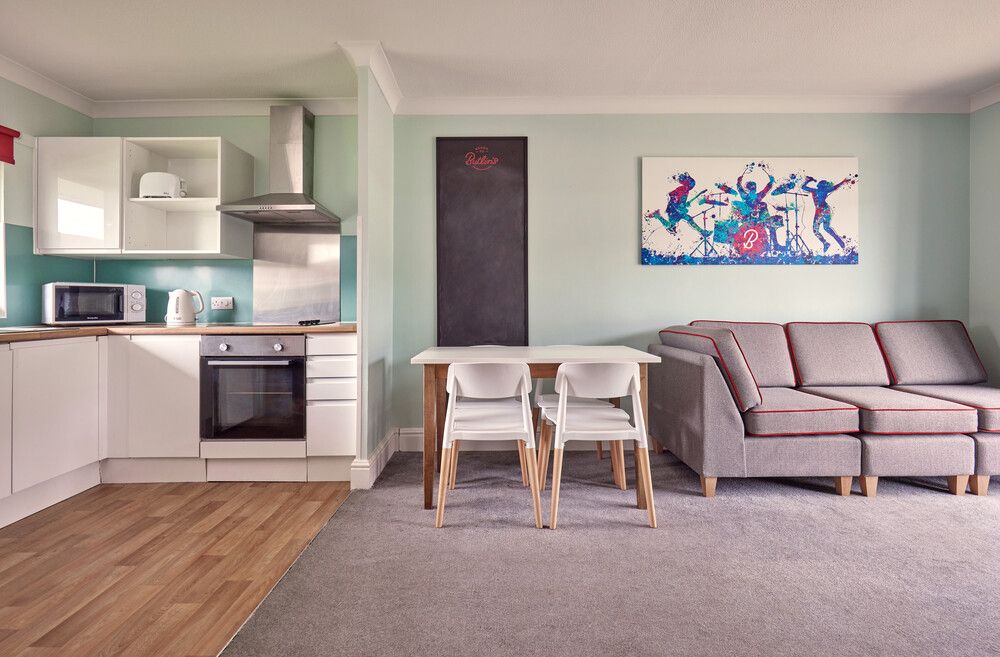 A living room and kitchen with dining area in our Comfort Plus Apartments at Minehead.