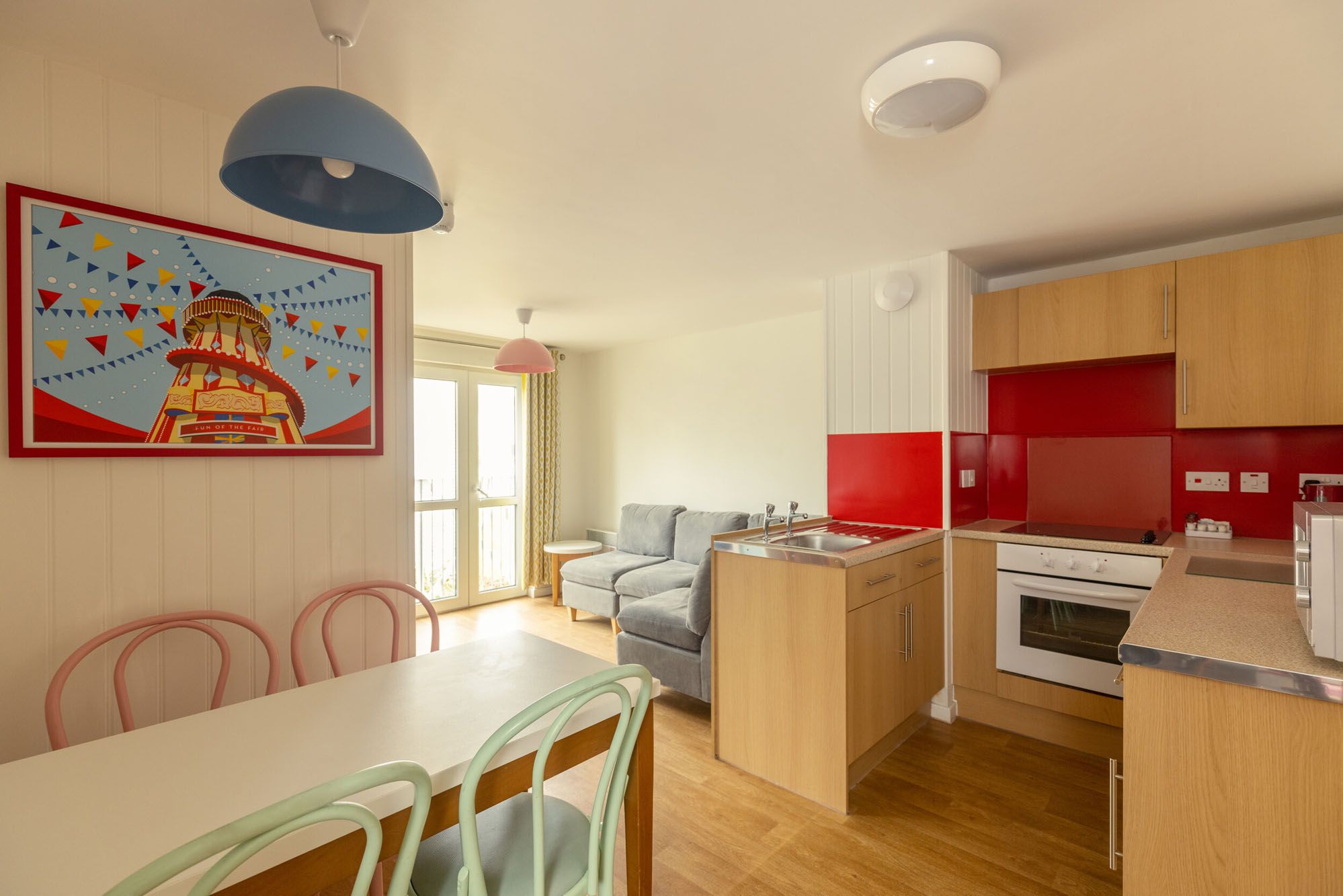 A living room and kitchen with dining area in our Fairground Apartments at Skegness.