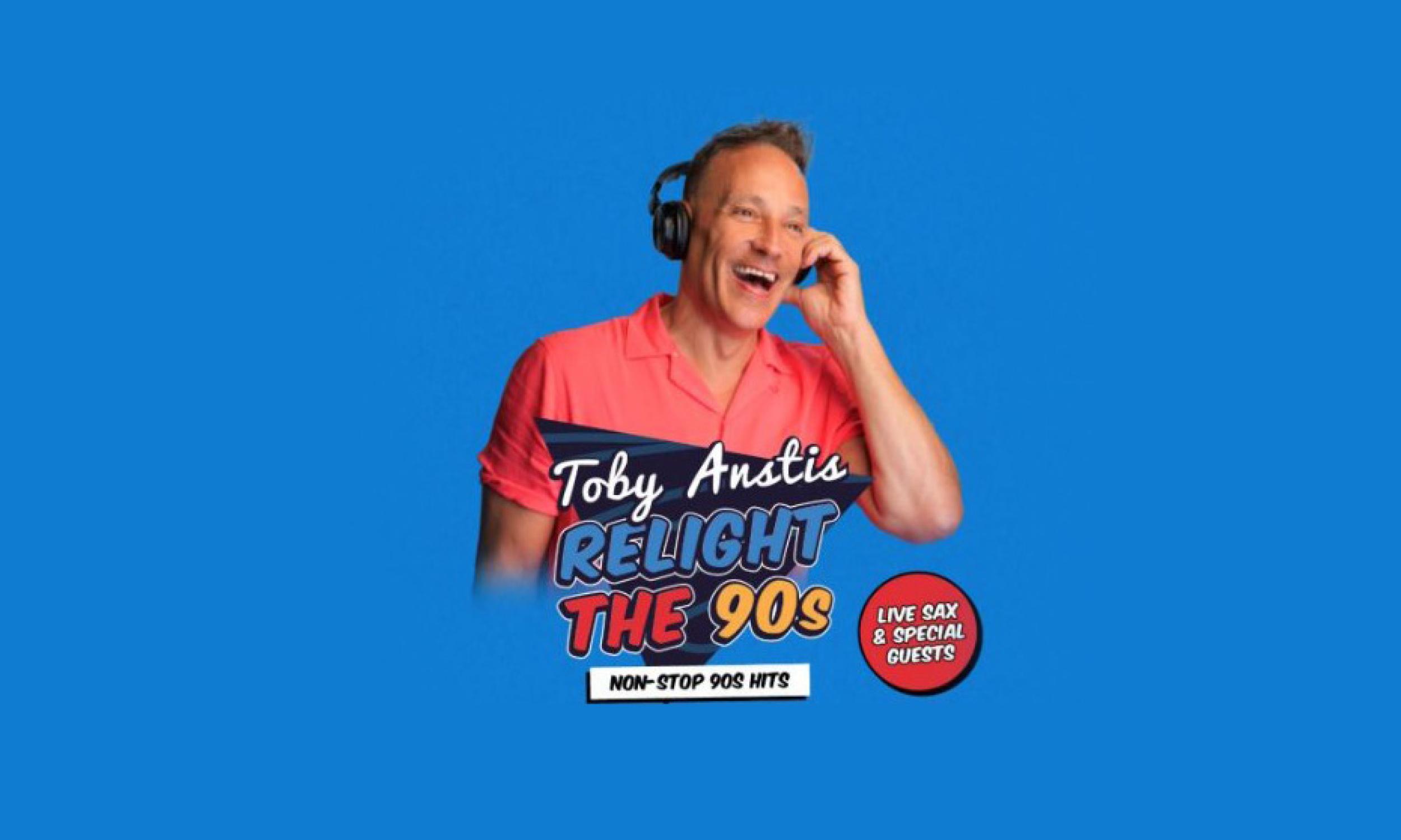Toby Anstis smiling and wearing headphones against a bright blue background, promoting his Relight The 90s show featuring non-stop 90s hits, live sax and special guests.