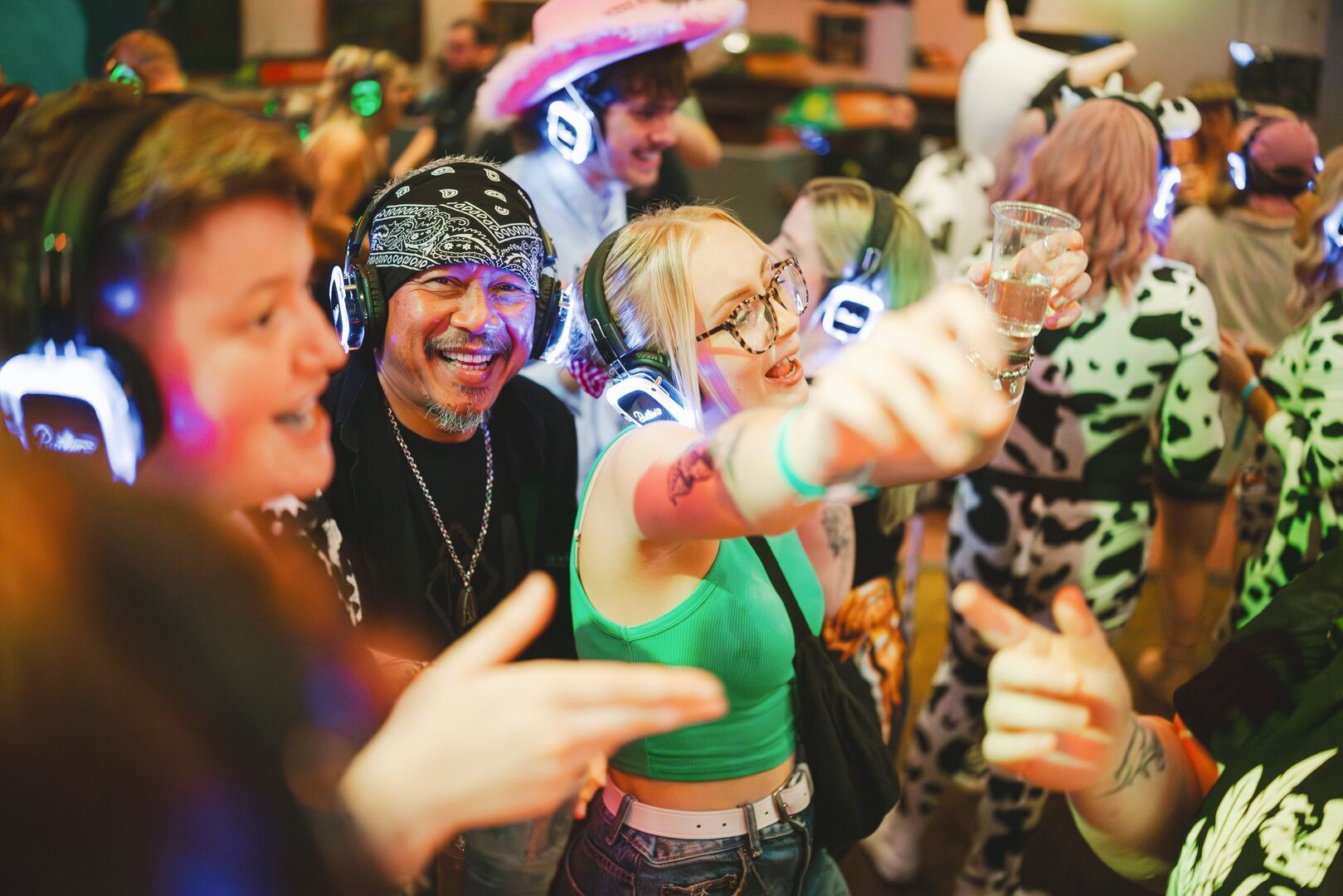 A close-up of several guests in the crowd, dancing and singing along to the Silent Disco at Minehead resort.