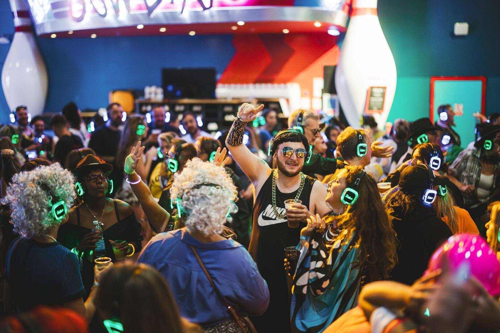 The crowd, singing and dancing together during the Silent Disco activity.