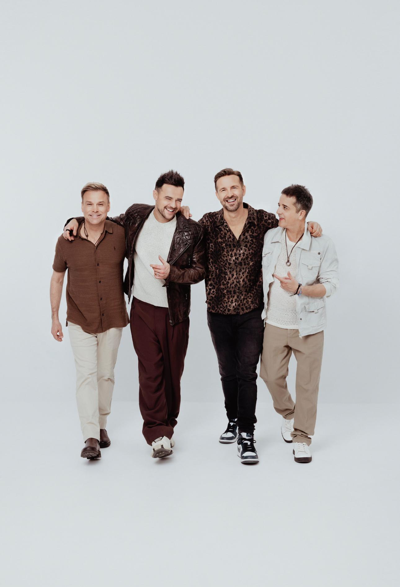 Four members of A1 standing with a white background