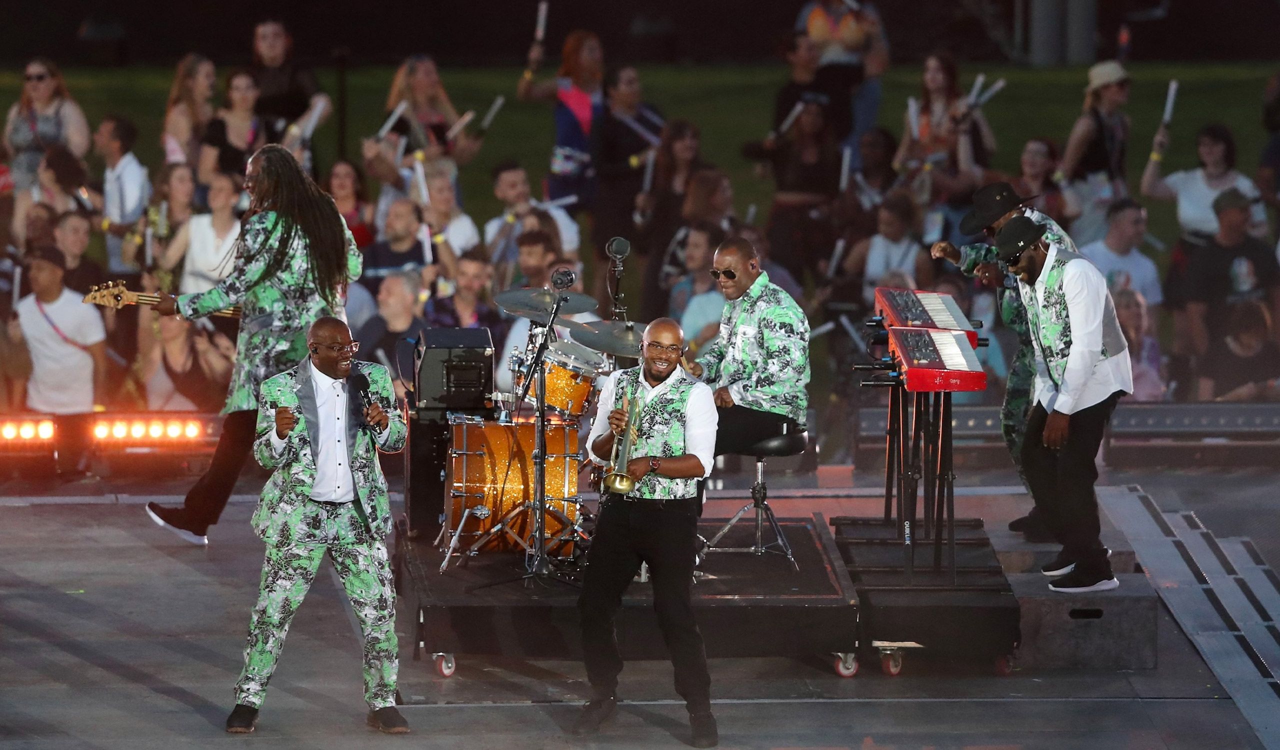 The members of Musical Youth on stage together with an audience surrounding them.