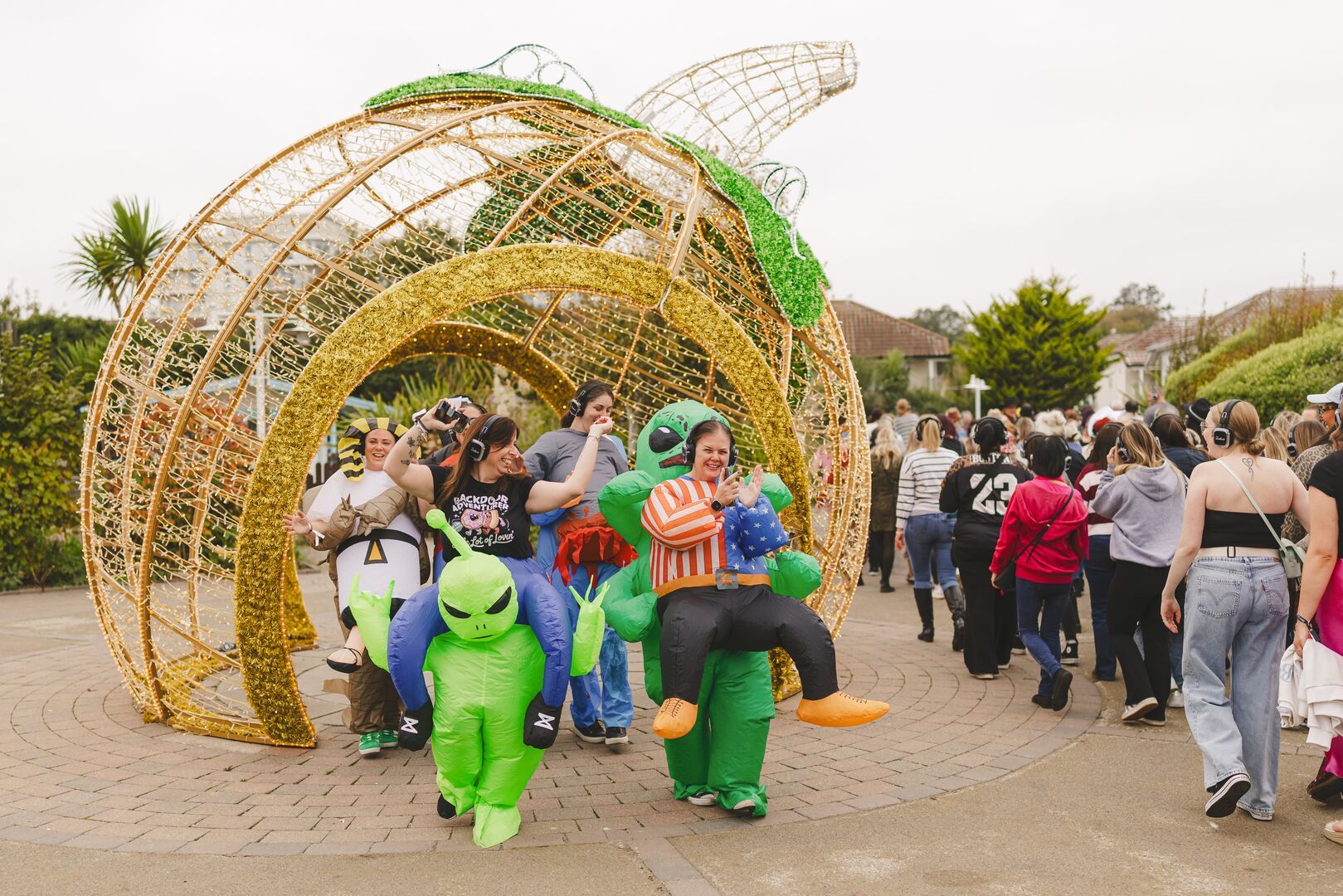 Big Weekender guests walk through a large pumpkin decoration during the Spooky Soul Stroll activity.