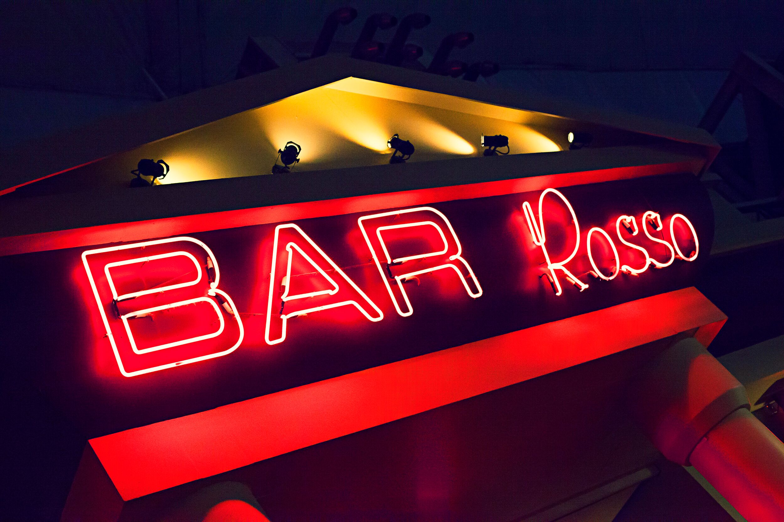 An illuminated signage of "BAR Rosso".