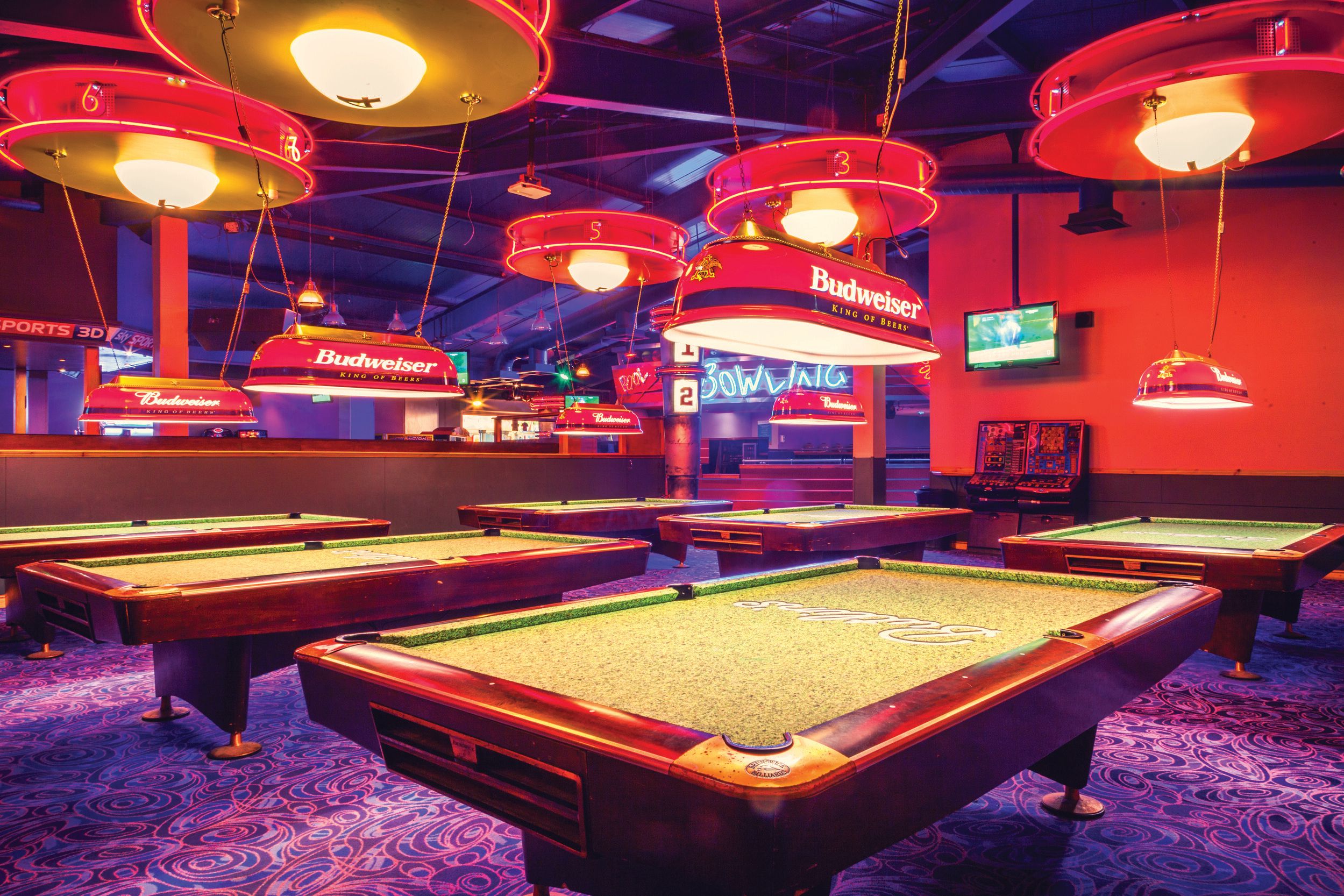 Set of billiard tables under the dim lights.