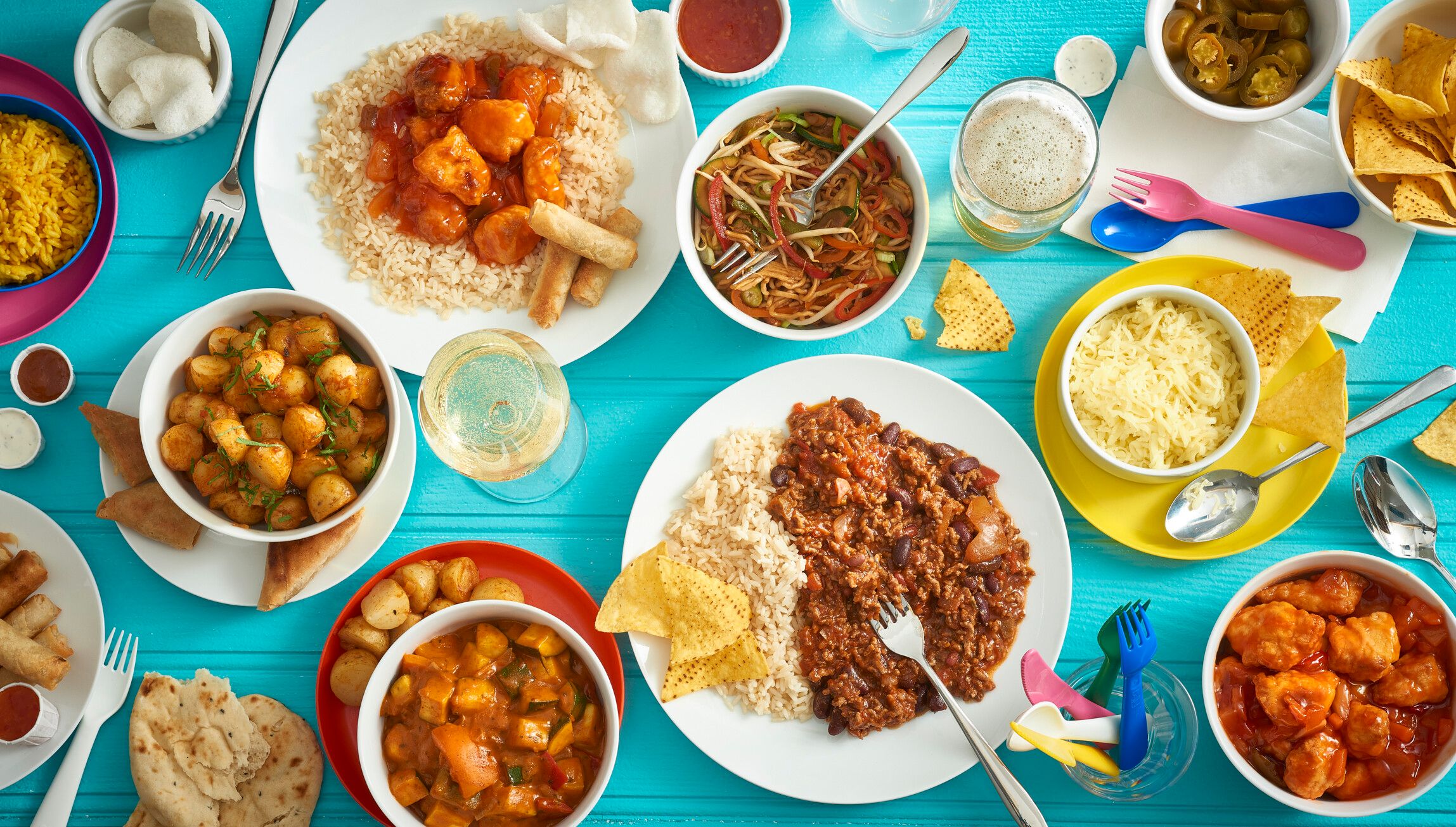 A table filled with foods such as potatoes, fillet and noodles.