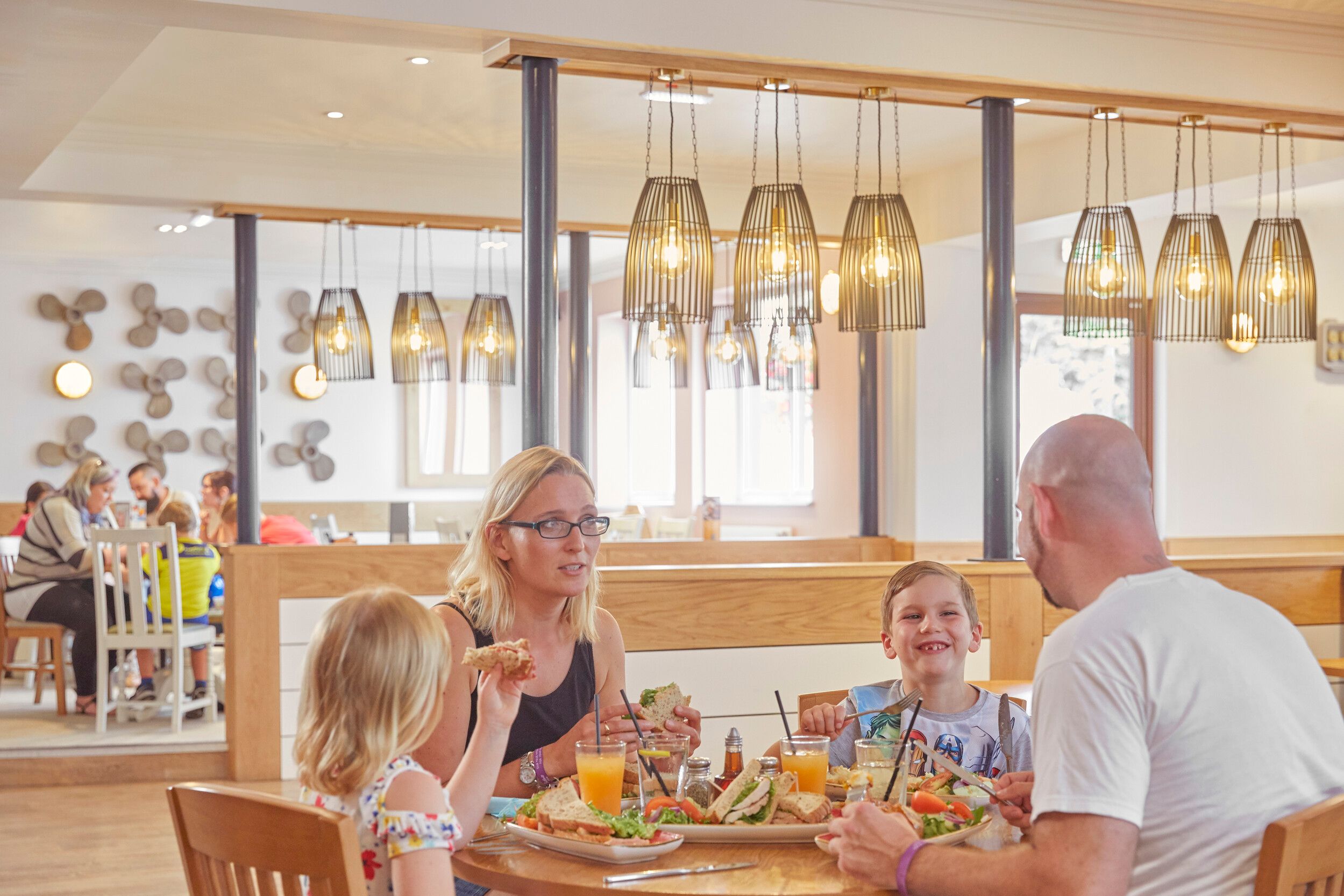 A family of four having their breakfast around the dining table.