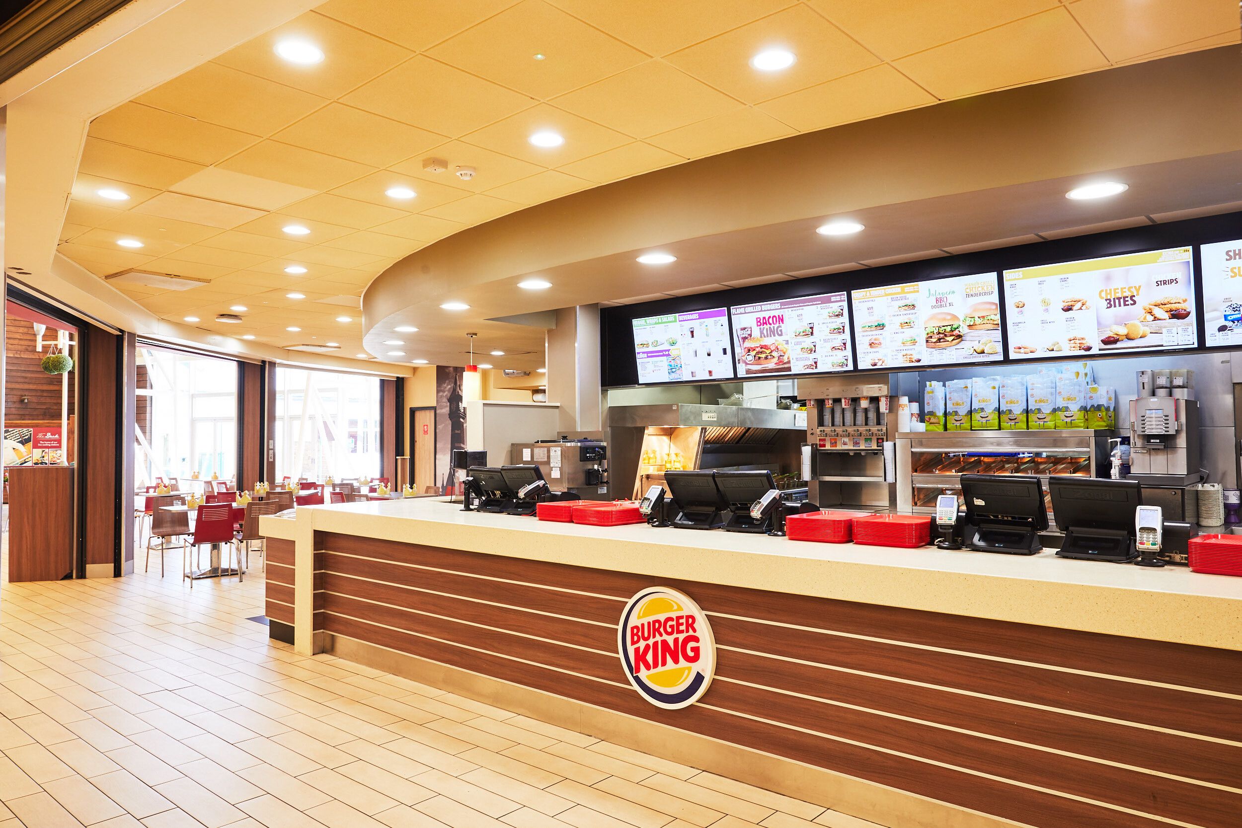 An empty Burger King counter and dining area.