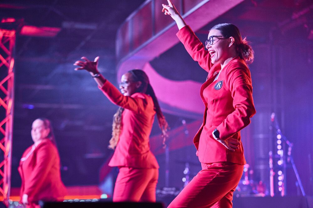 Three Redcoats perform on stage together for live show at Butlin's.