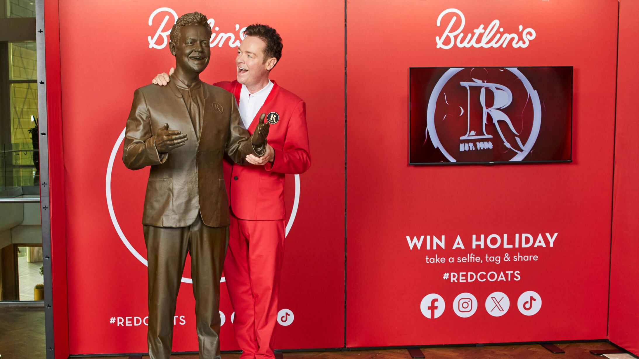 Stephen Mulhern stands next to a statue created in his likeness.