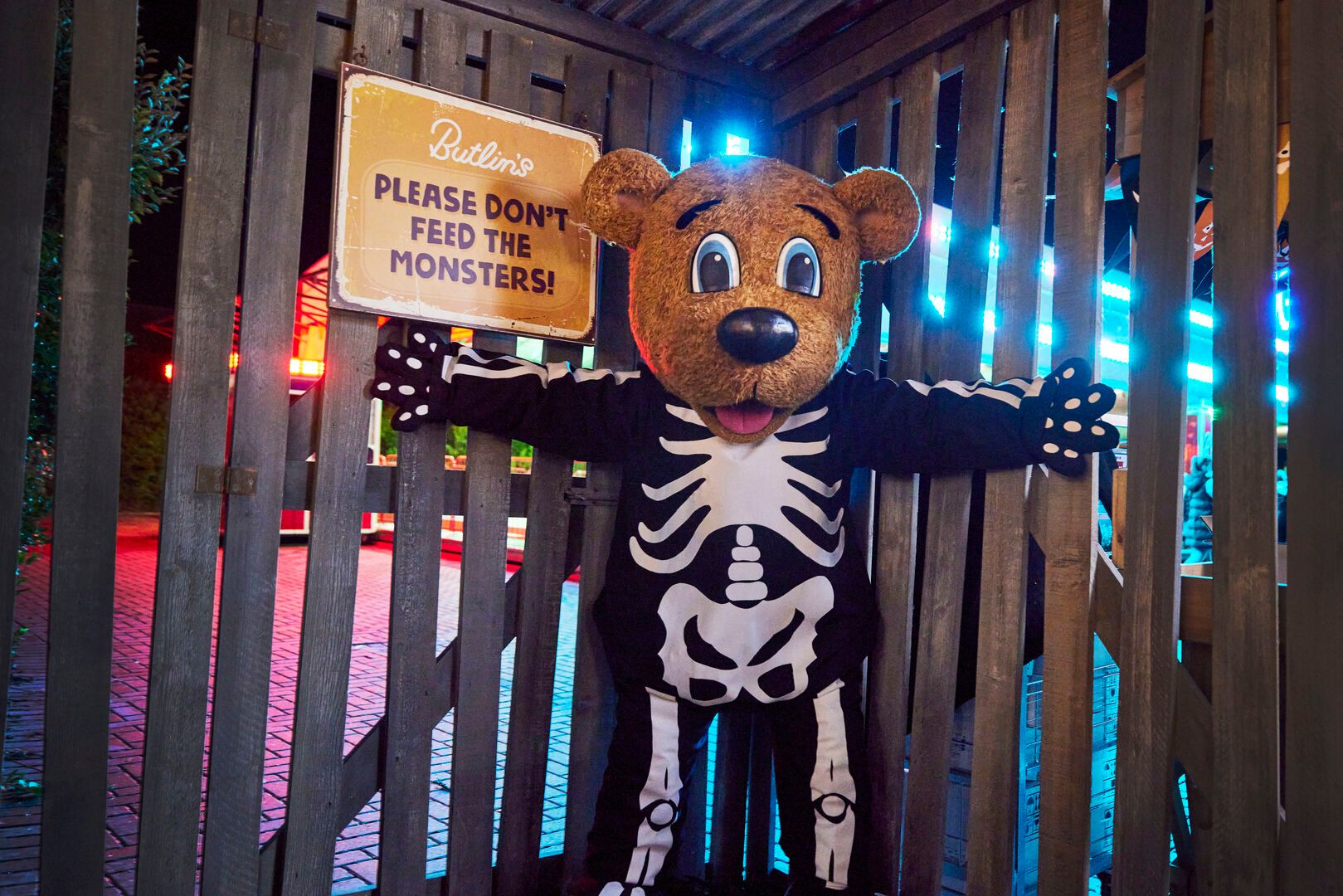 Billy Bear dressed in a skeleton costume poses in the Scareground on a Halloween break.