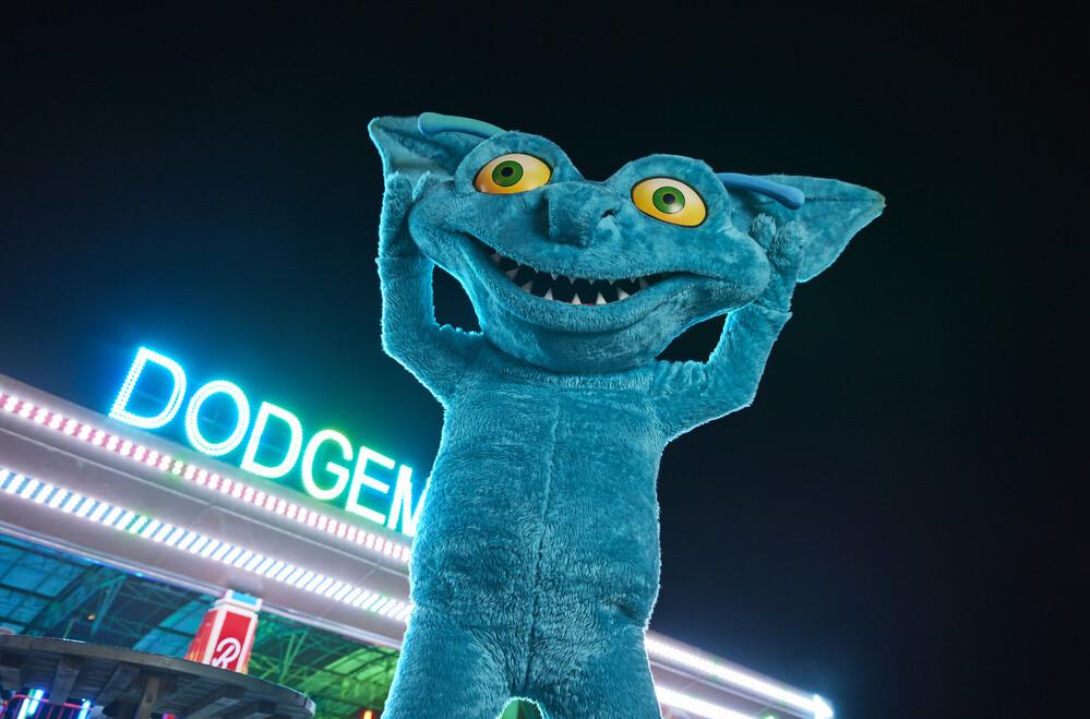 A blue monster mascot posing at the camera.