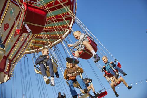 Young children enjoying the Skegness fairground carousel.