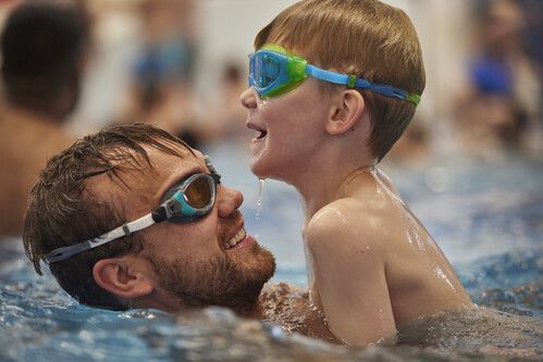A father and son play in the water at Splash Waterworld.