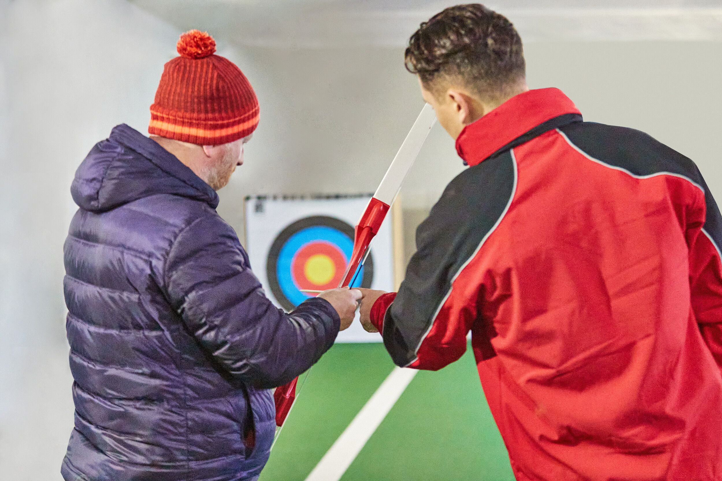 A man preparing to take a shot in an Archery range.