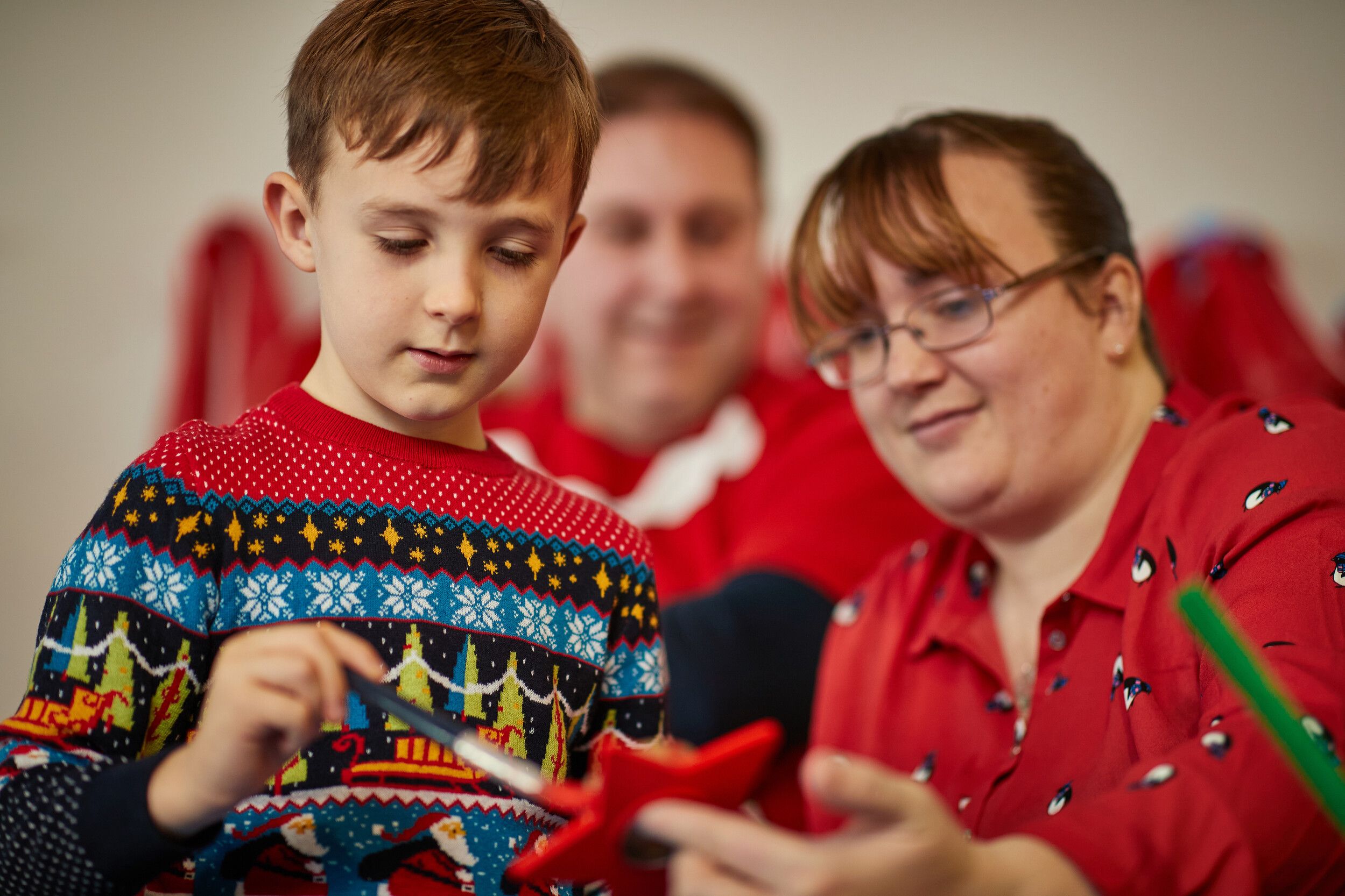 A boy painting some art work.