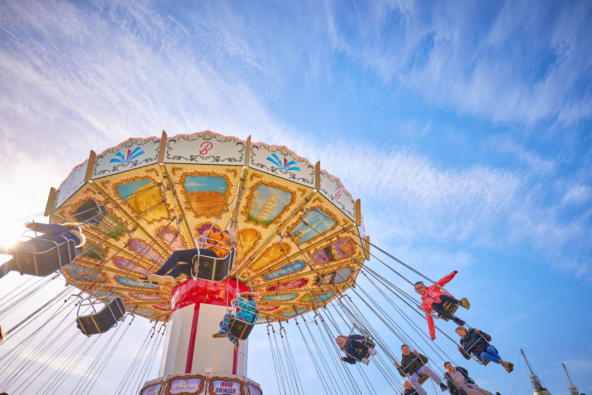 Several guests ride the Waveswinger fairground ride at Bognor Regis resort.