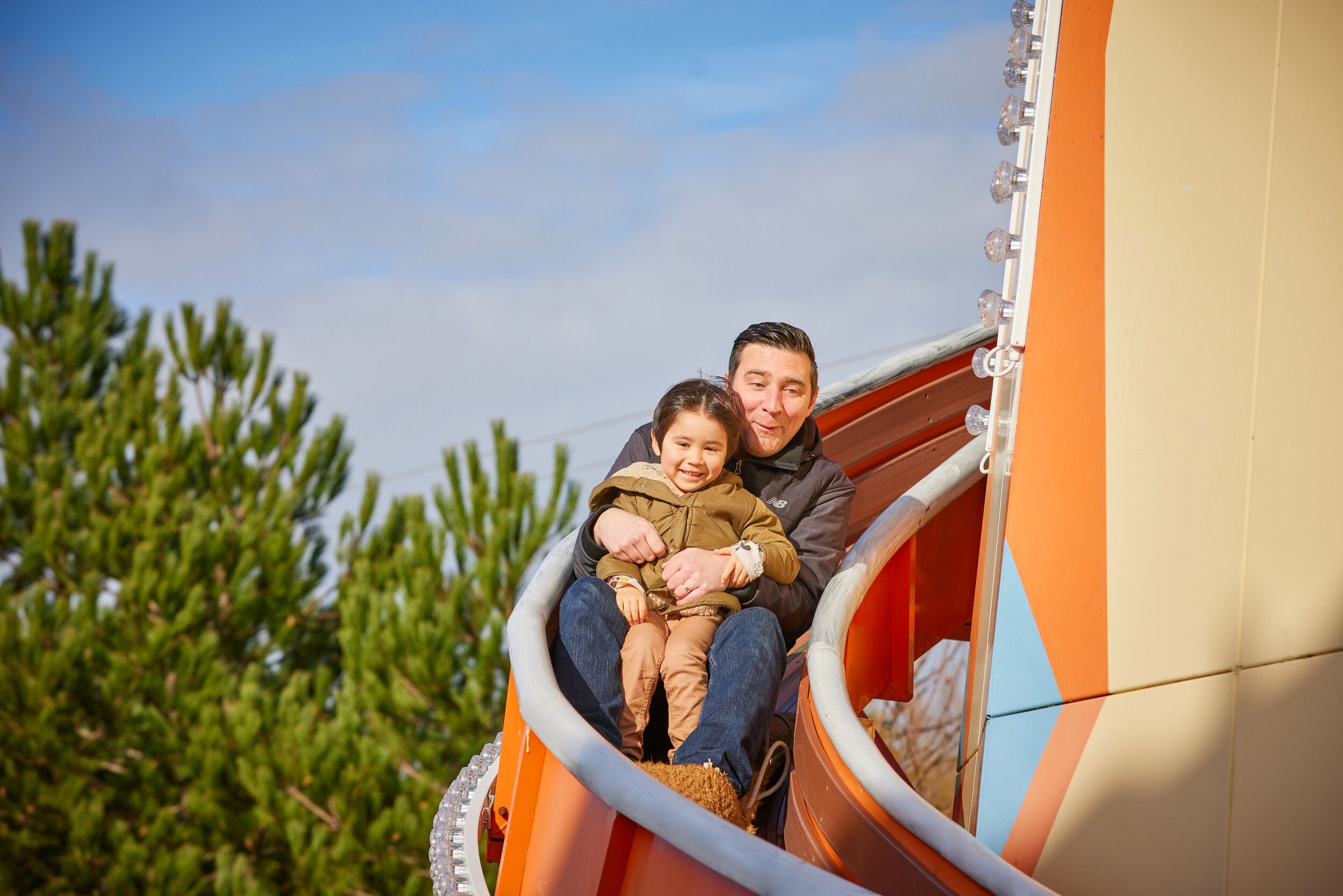 A father and daughter sliding down the Helter Skelter together at Bognor Regis.