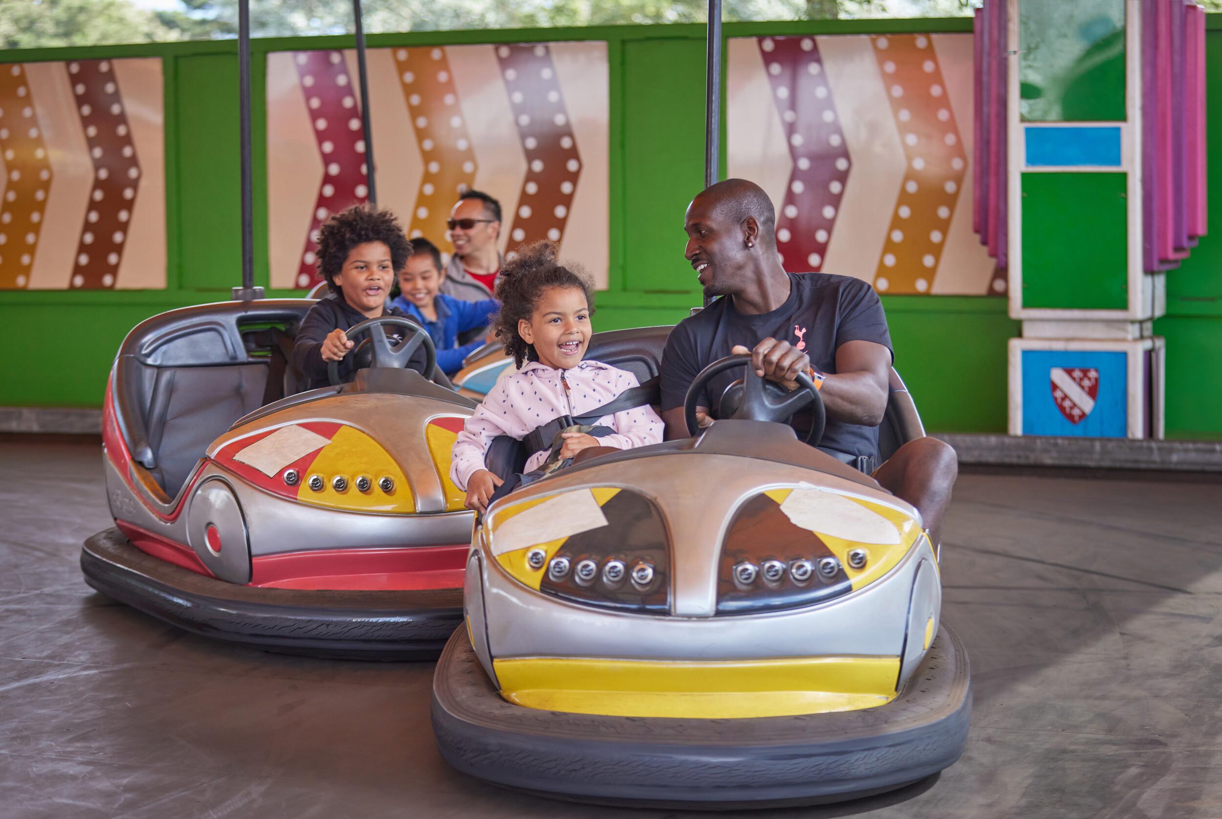 Several guests riding bumper cars at Bognor Regis fairground.
