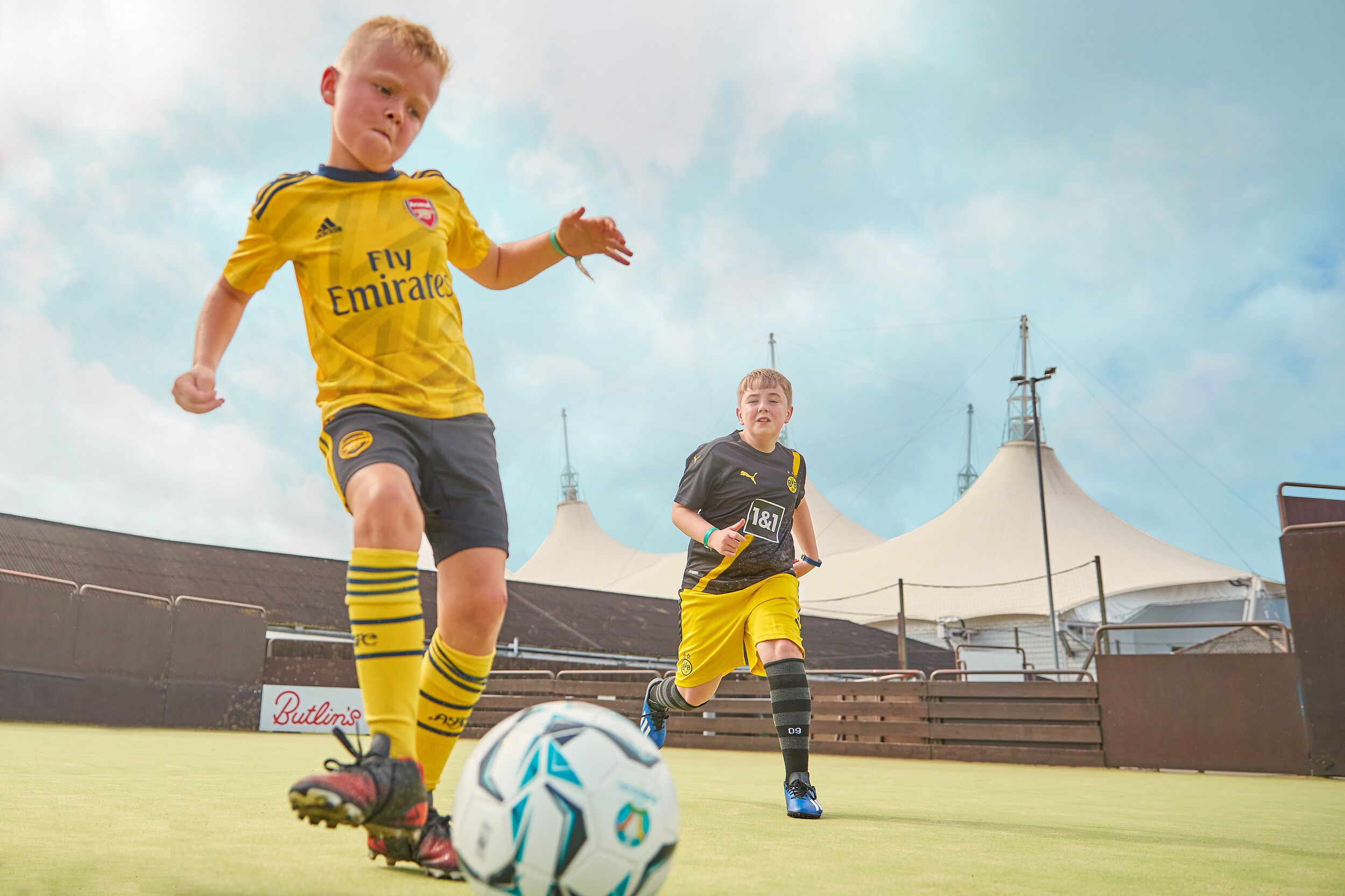 Two boys playing football together.