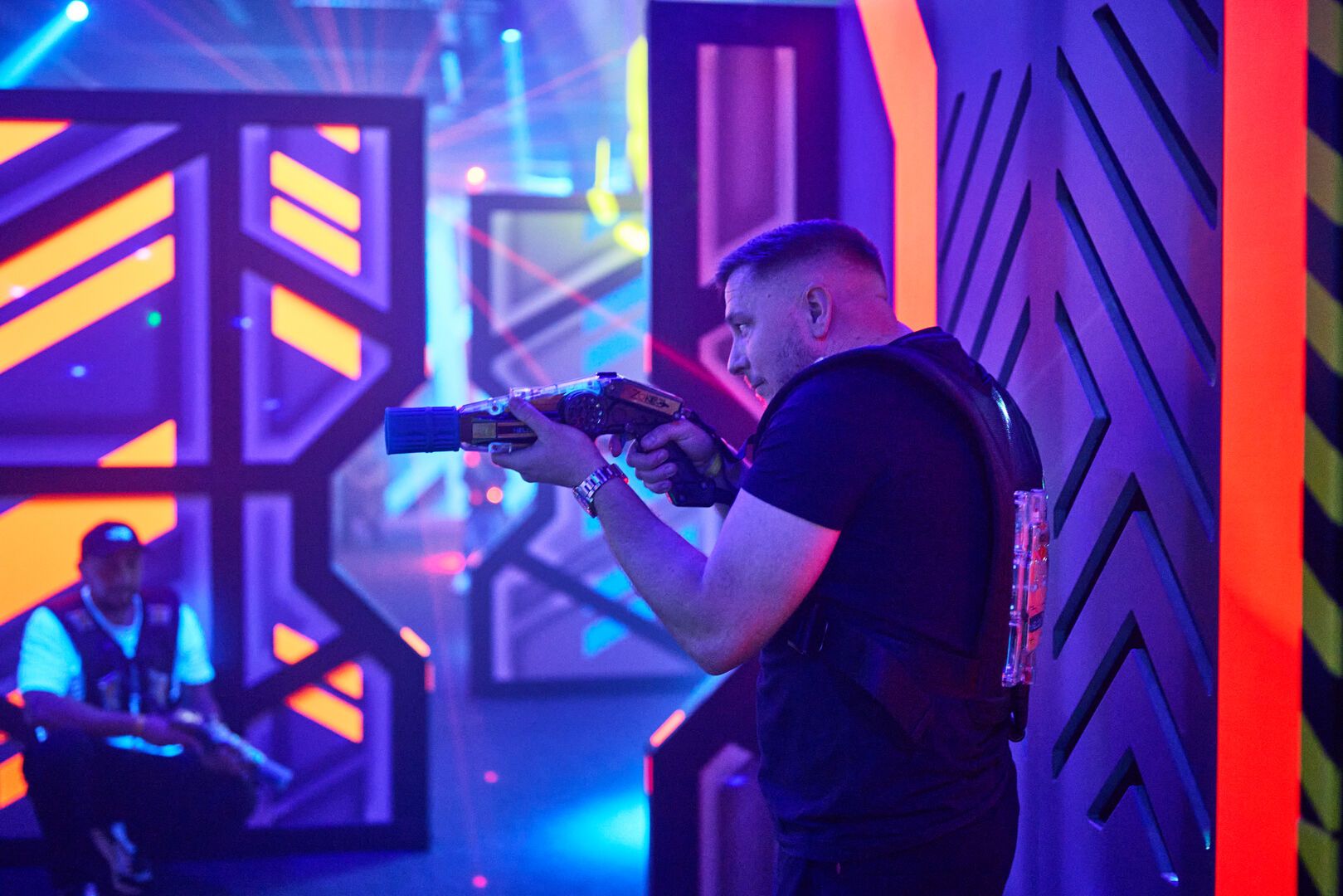 A man aims his Laser Tag gun.