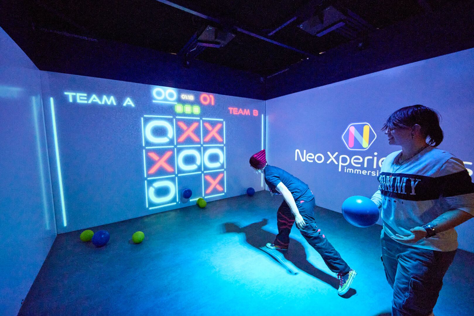 Two people play an interactive game together at Playxperience.
