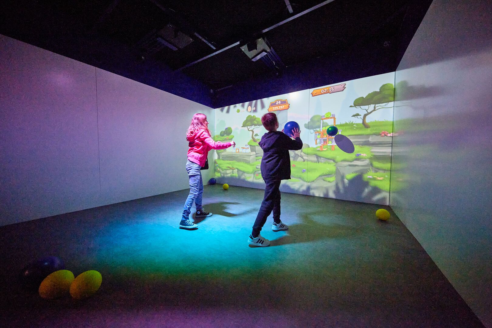 Two people play an interactive game together at Neo Games in Playxperience.