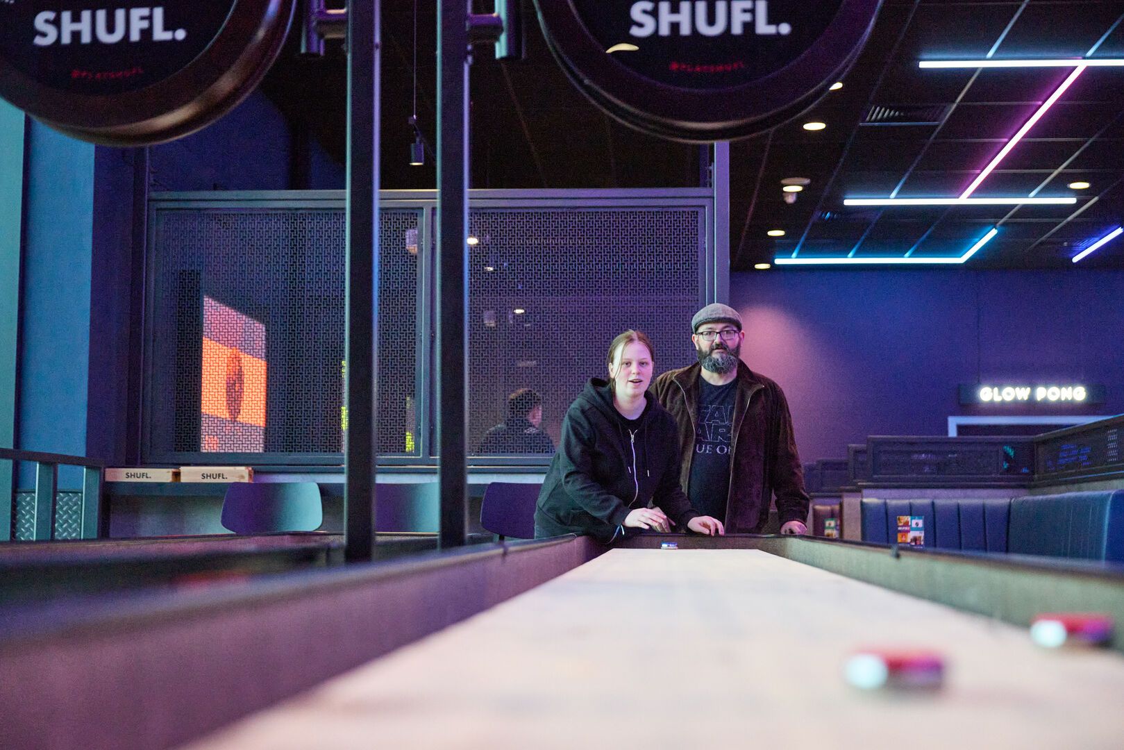 Two people play Shuffleboard together at Playxperience in Bognor Regis.