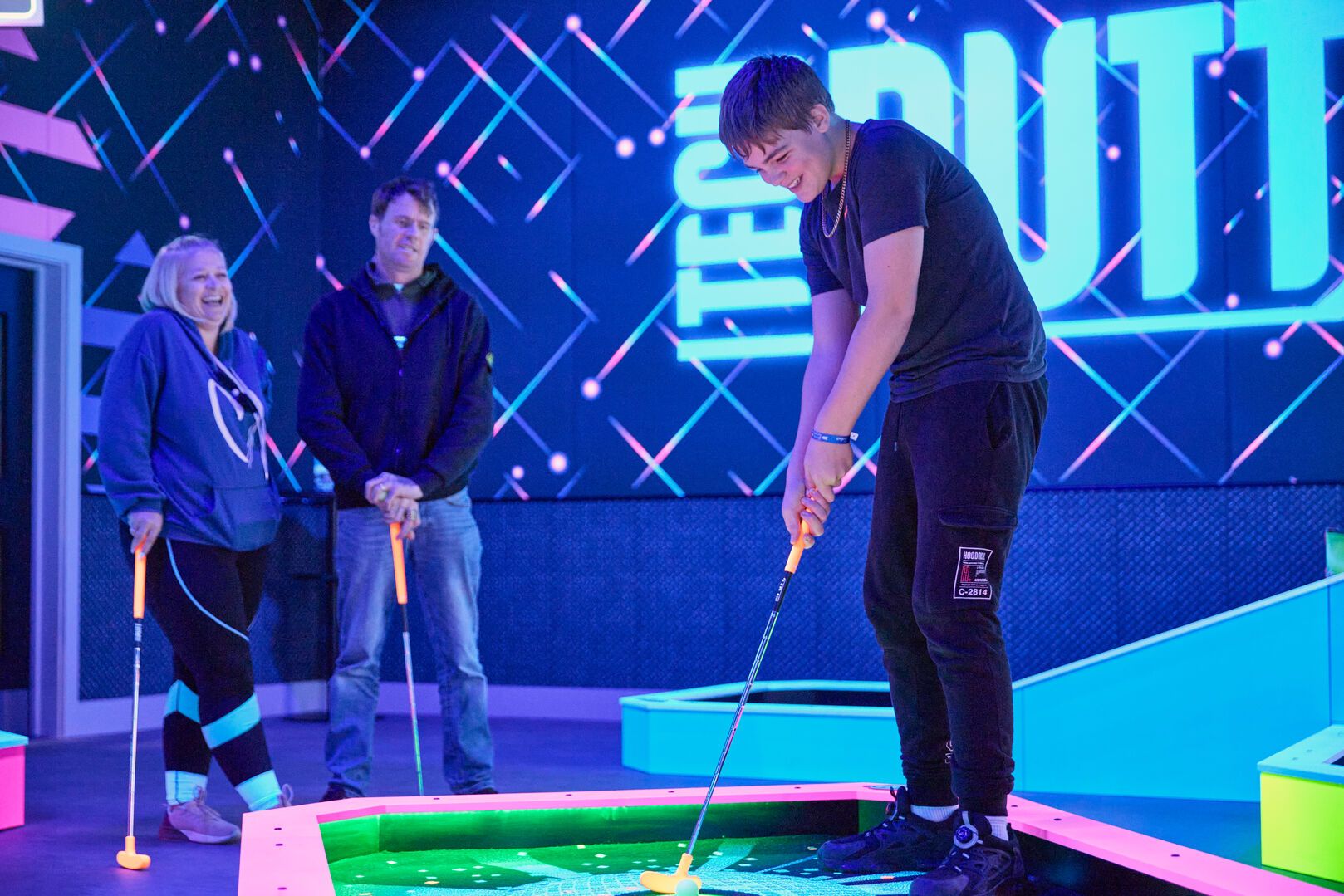 A family play Tech Putt together at Bognor Regis Playxperience.