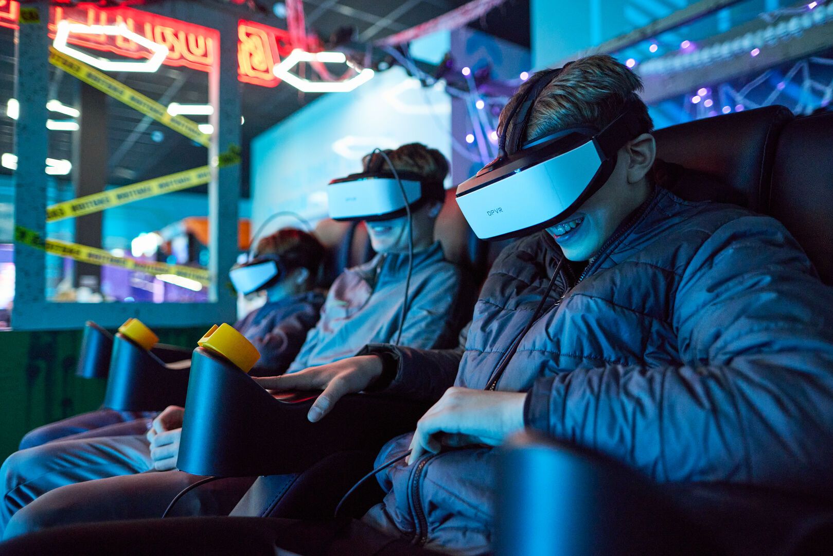 A close-up of someone smiling while playing a game at the VR-Cade.
