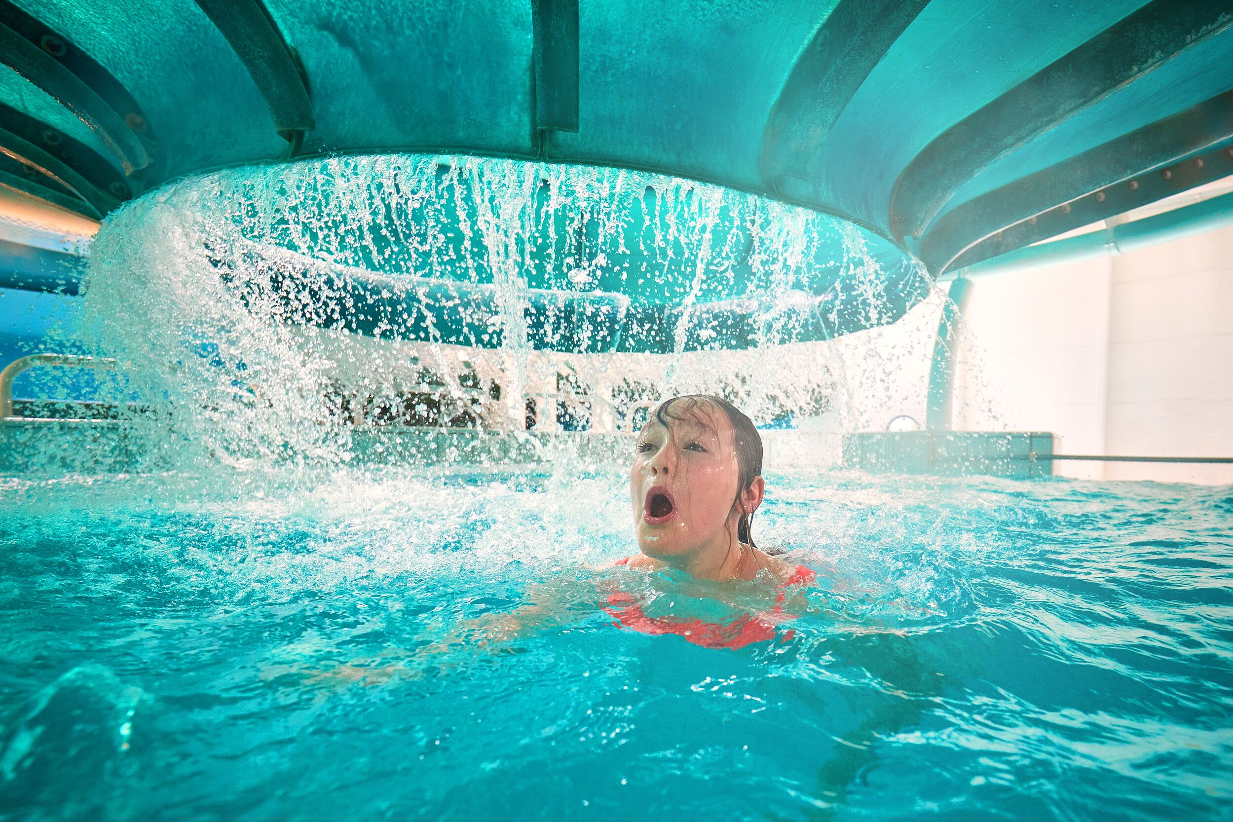 A young girl surfacing from the Space Bowl water ride.