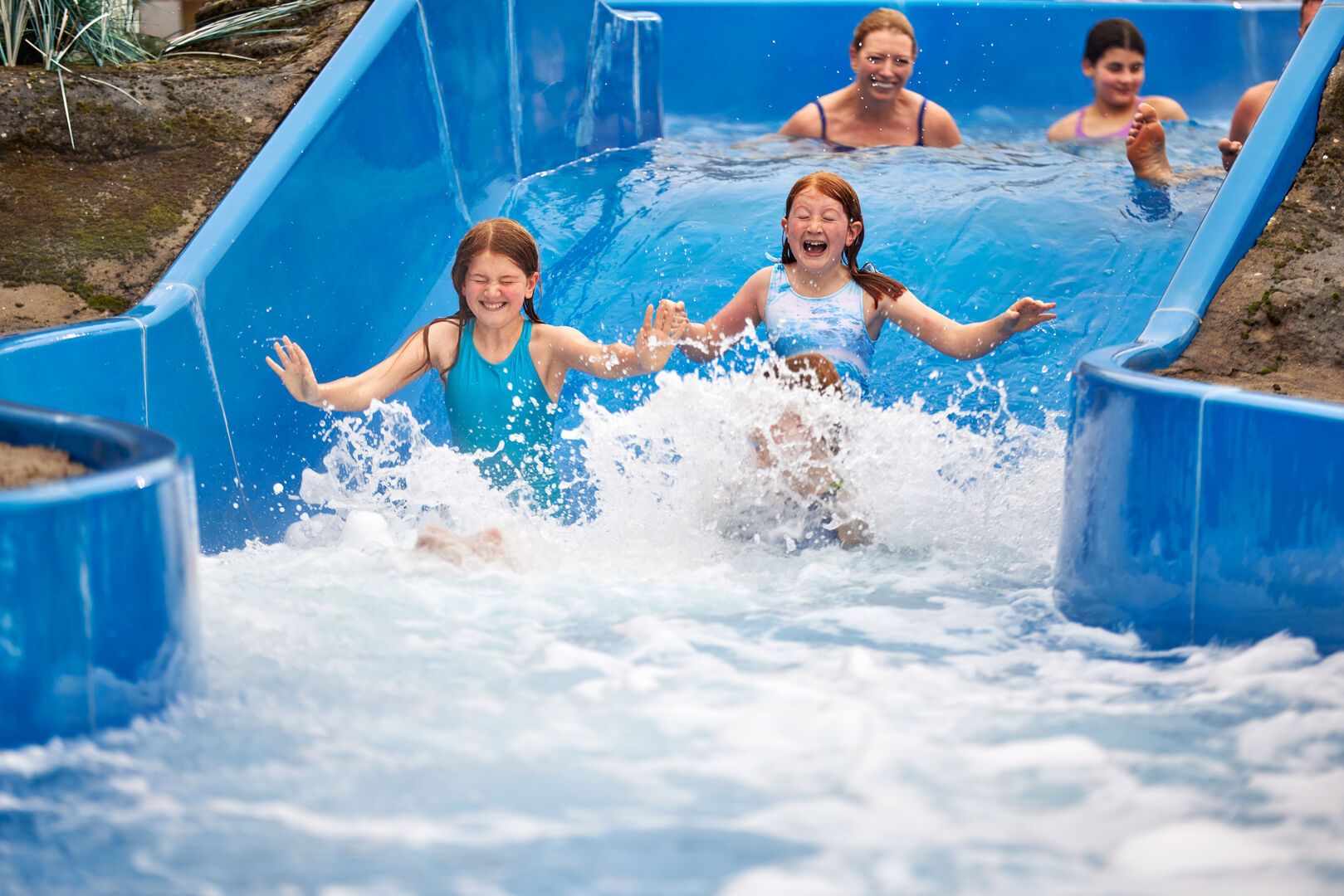 Two young girls go down the rapids together at Skegness Splash Waterworld.