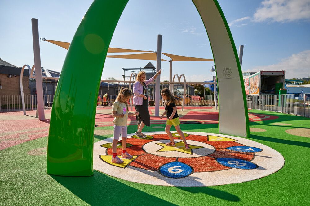 Two young girls play with their mother at the Butlin's Skypark.