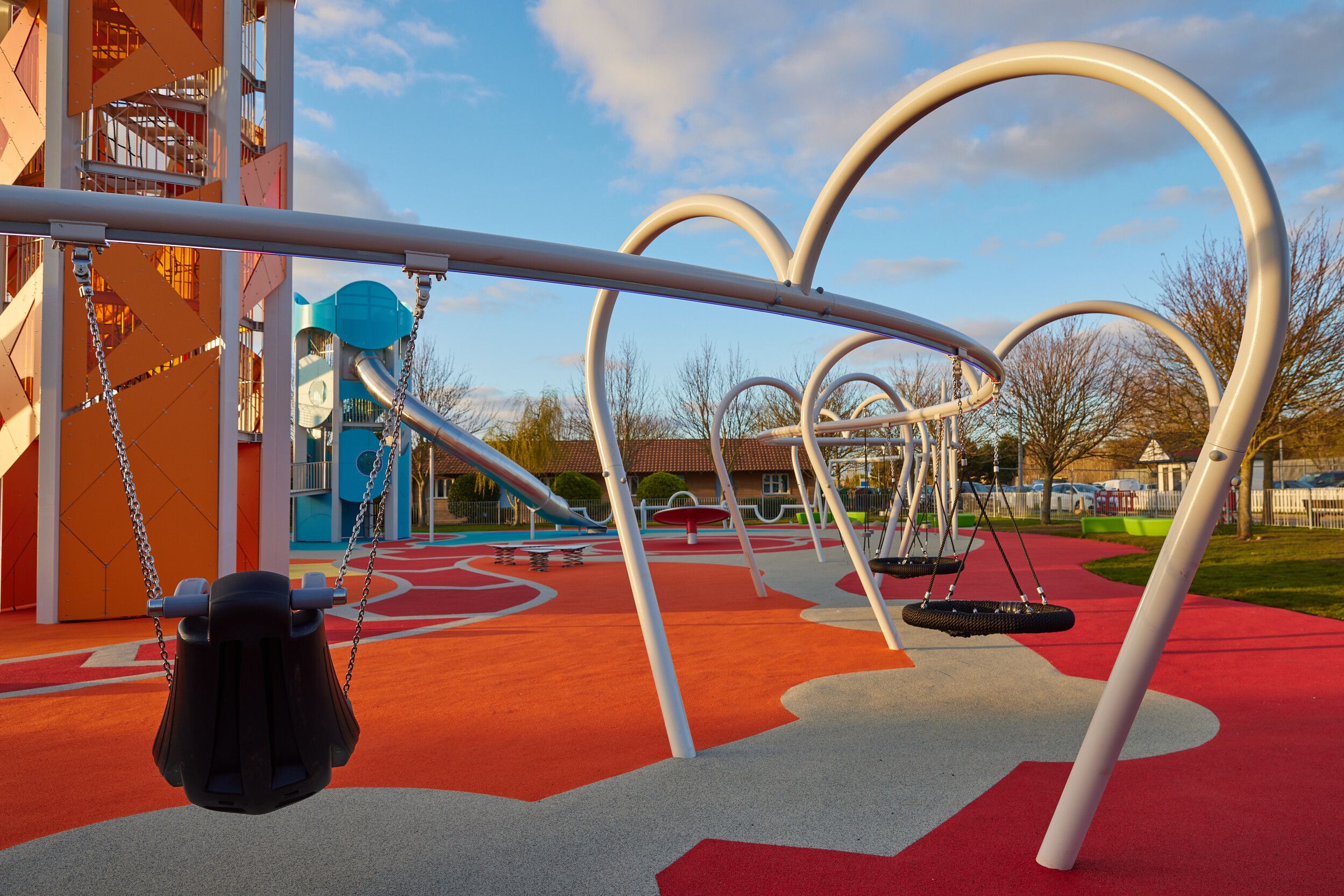 A colourful tower slides and swings in Skypark.