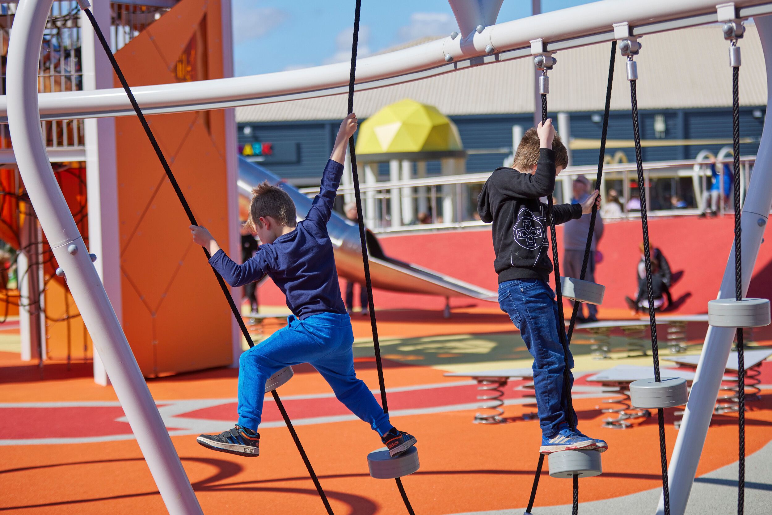 Two boys playing in Skypark during the day.