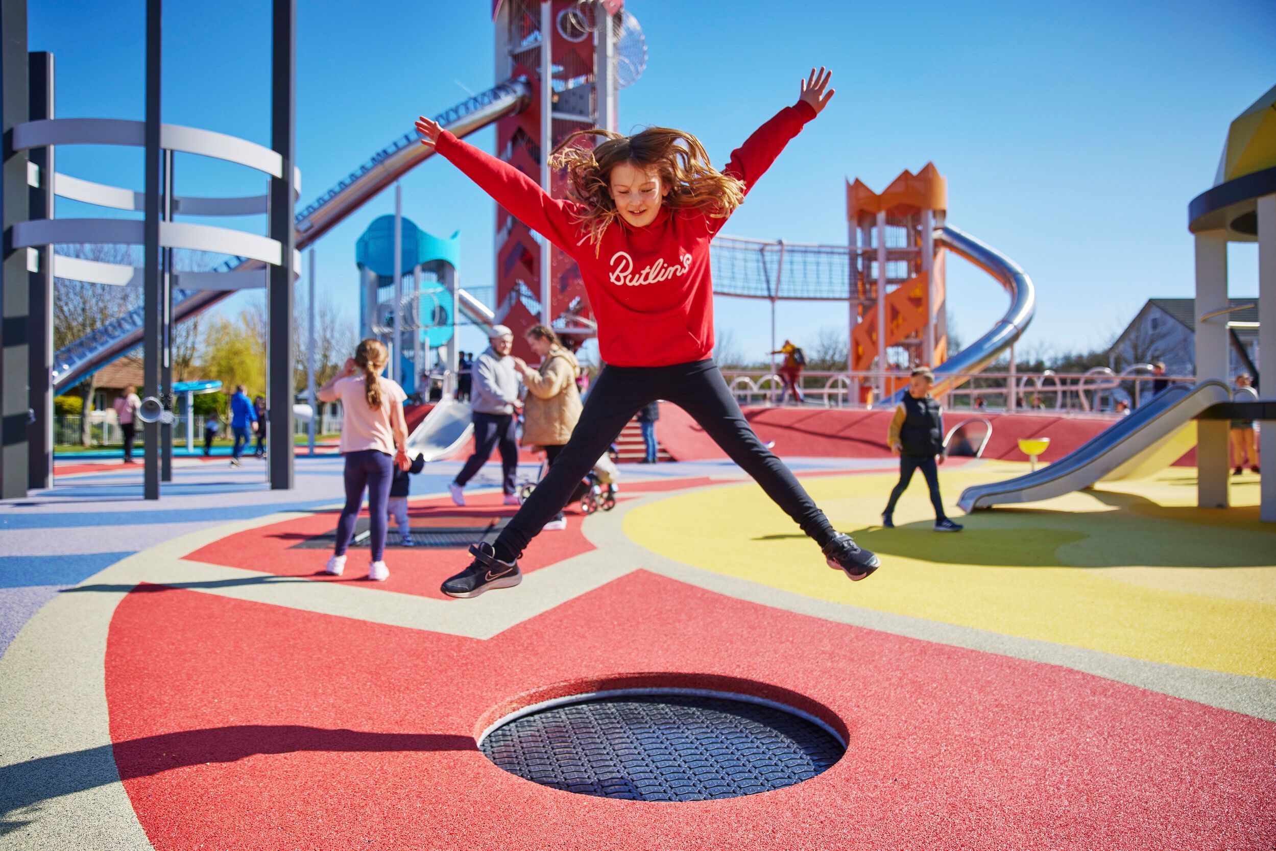 A girl jumping on a trampoline in Skypark.