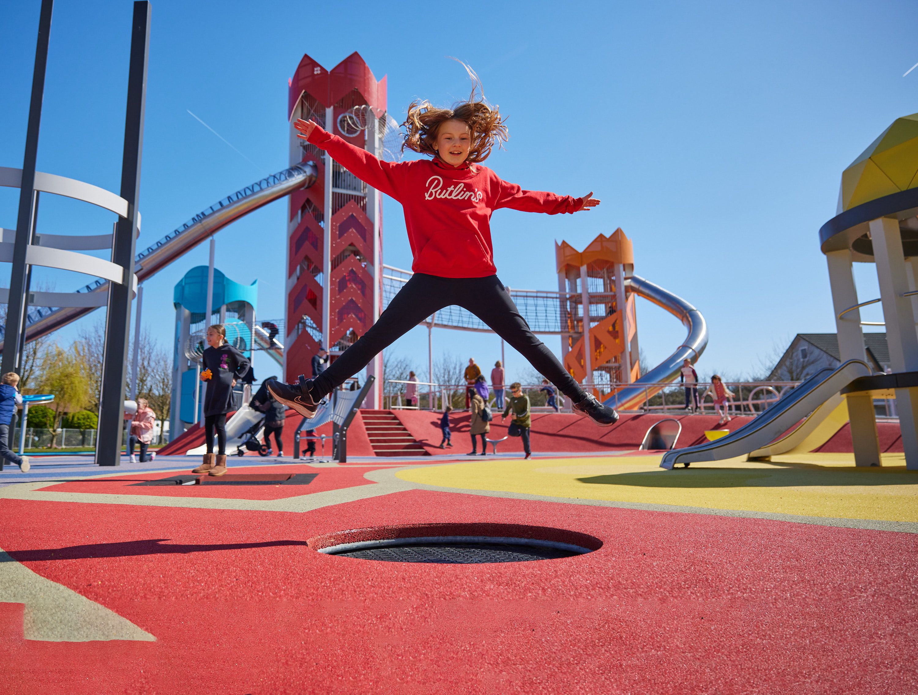 A group of kids playing in Skypark during the day.