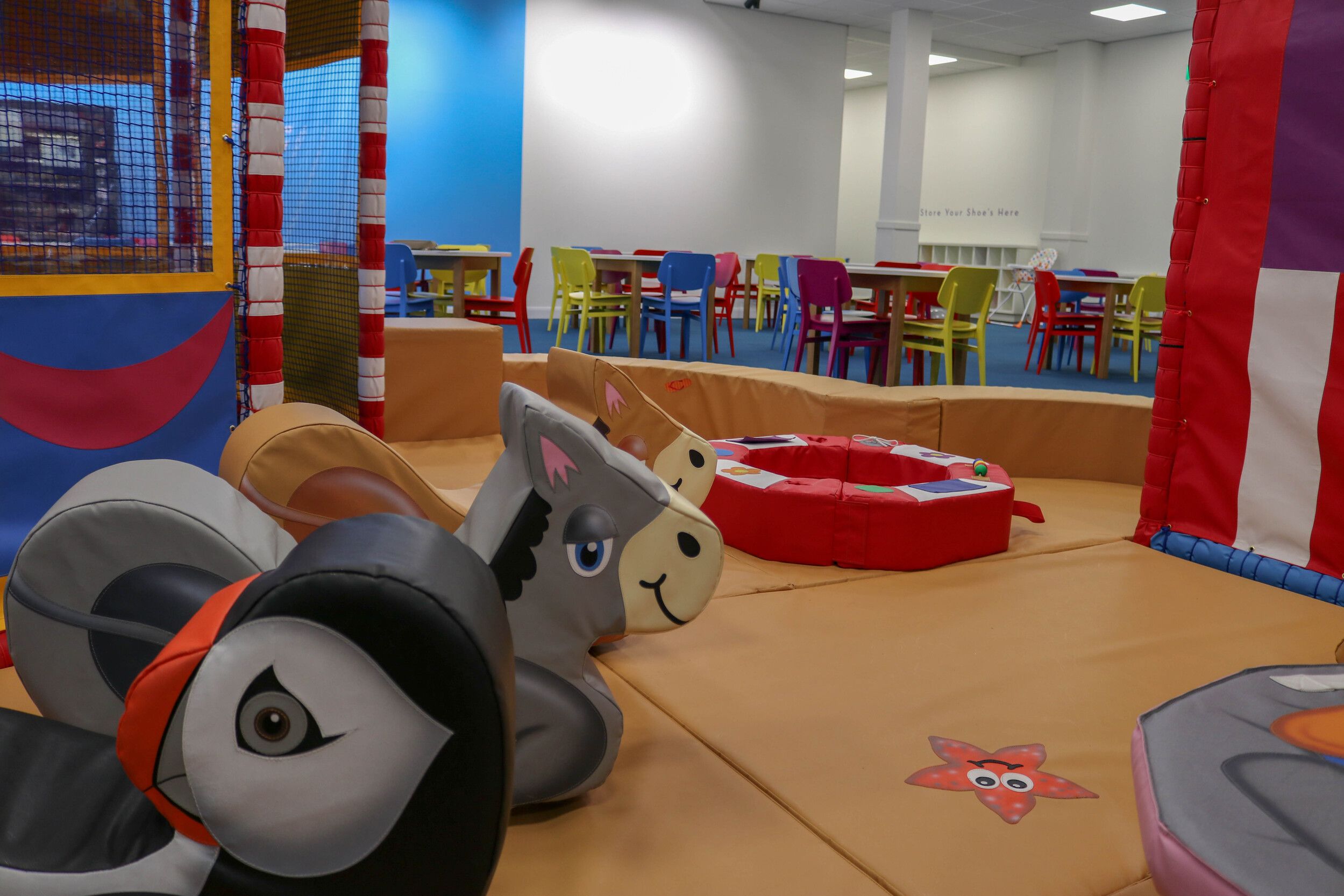 A colourful indoor play area with dining area.