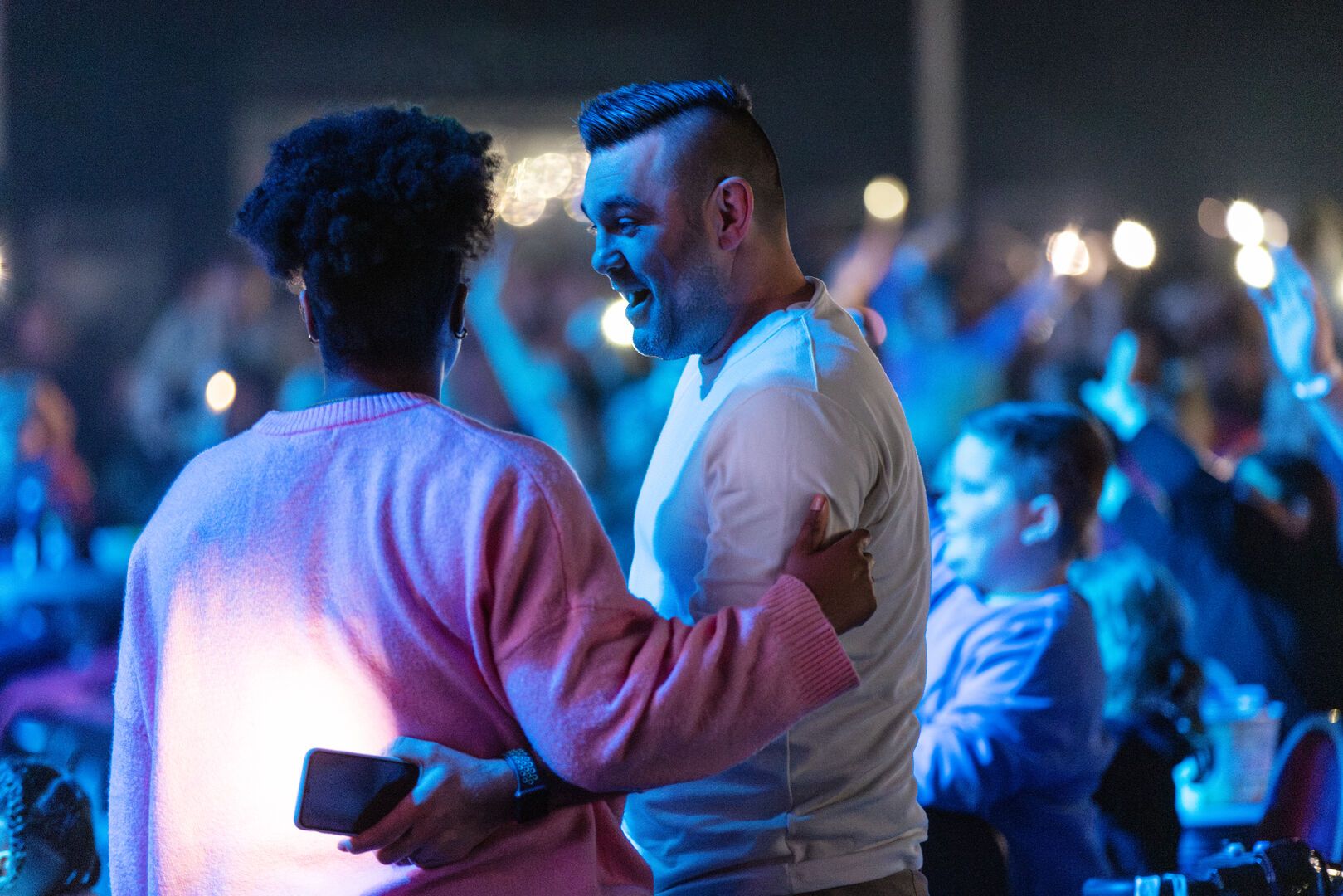 A couple stand together as they watch the Animals and Mythical Beasts show.