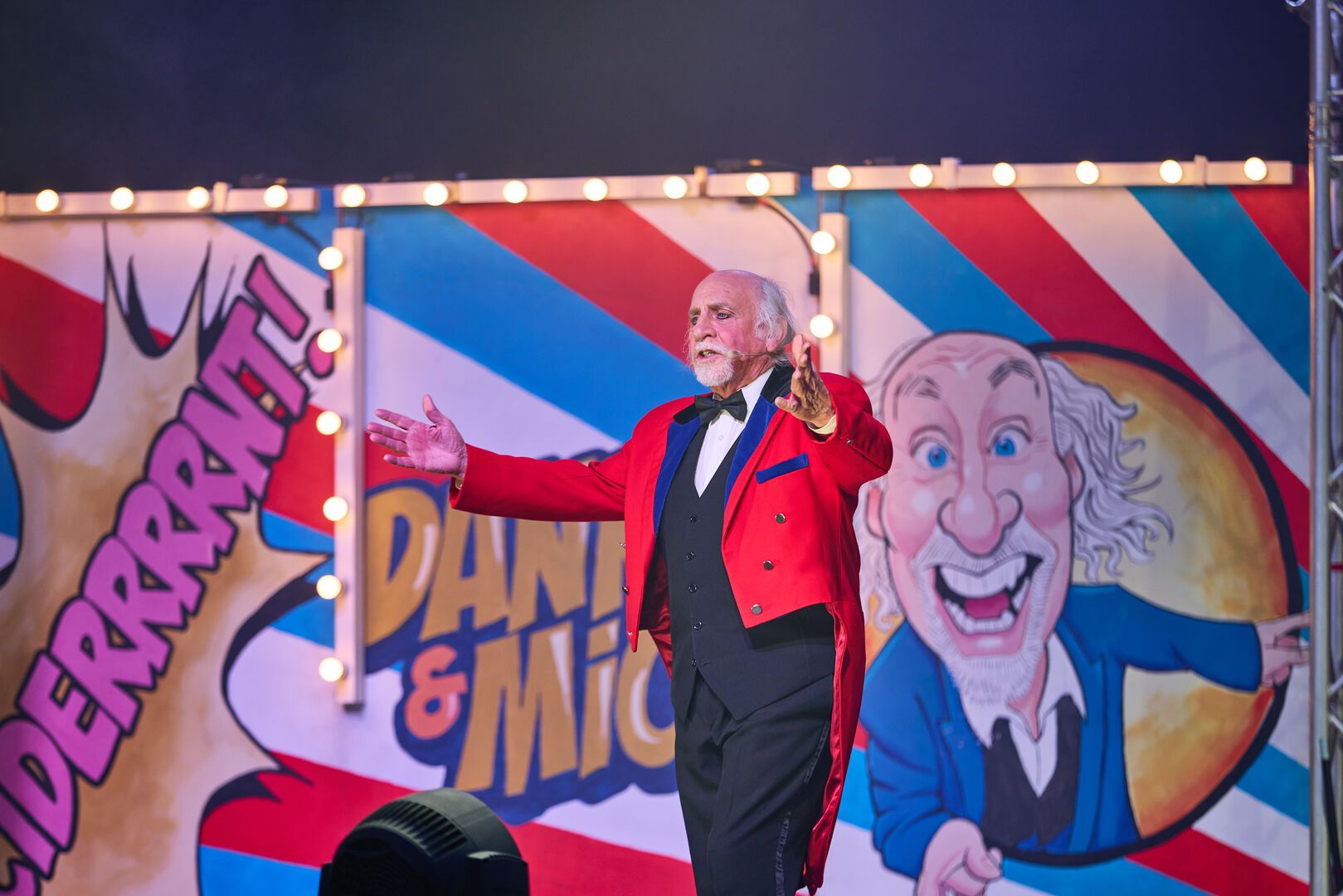 A close-up of Clive Webb performing on stage for the Cirque Du Hilarious live show.