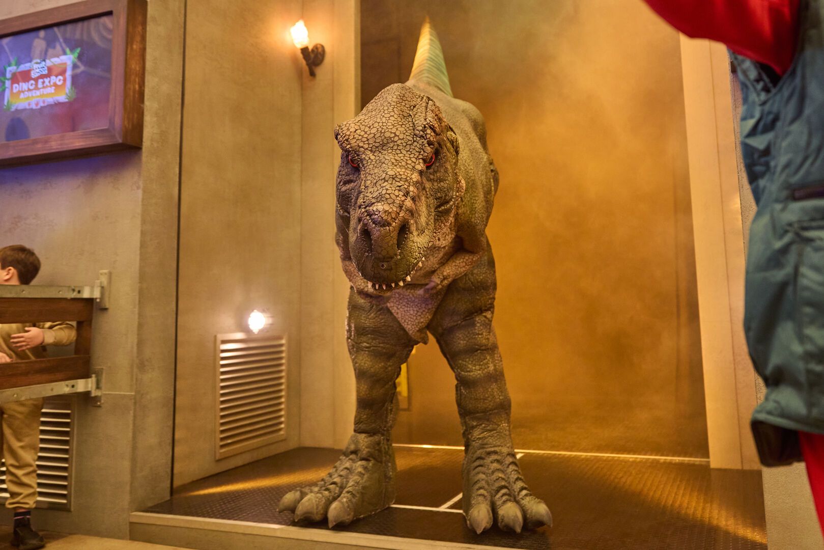 A T-Rex stands in a smokey doorway as part of the Dino Expo experience at Butlin's.