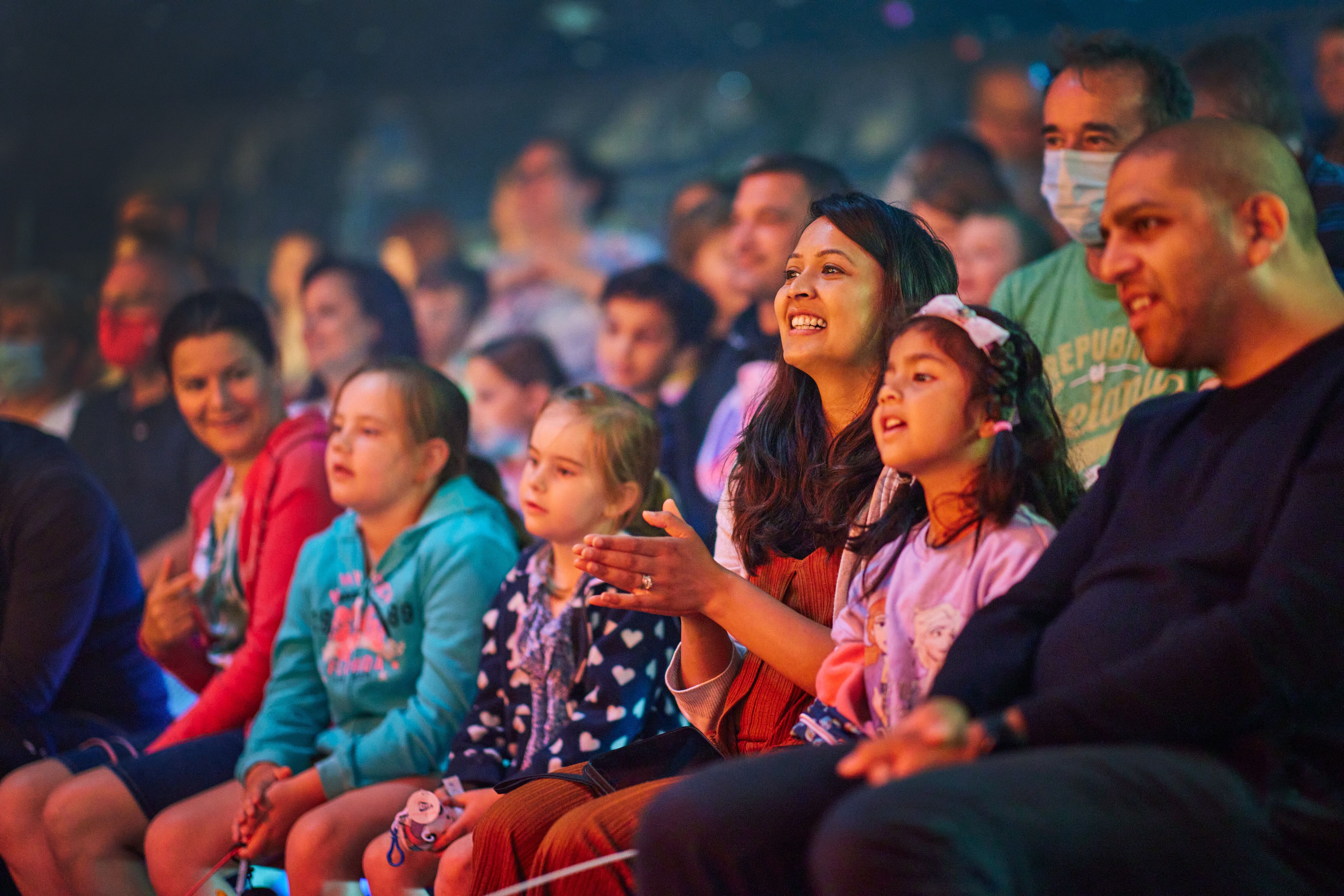 An audience sitting down while watching a show.