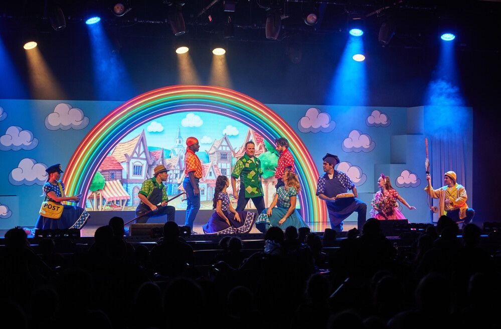 Jack & the Beanstalk characters played with a group of people while wearing costumes on stage.