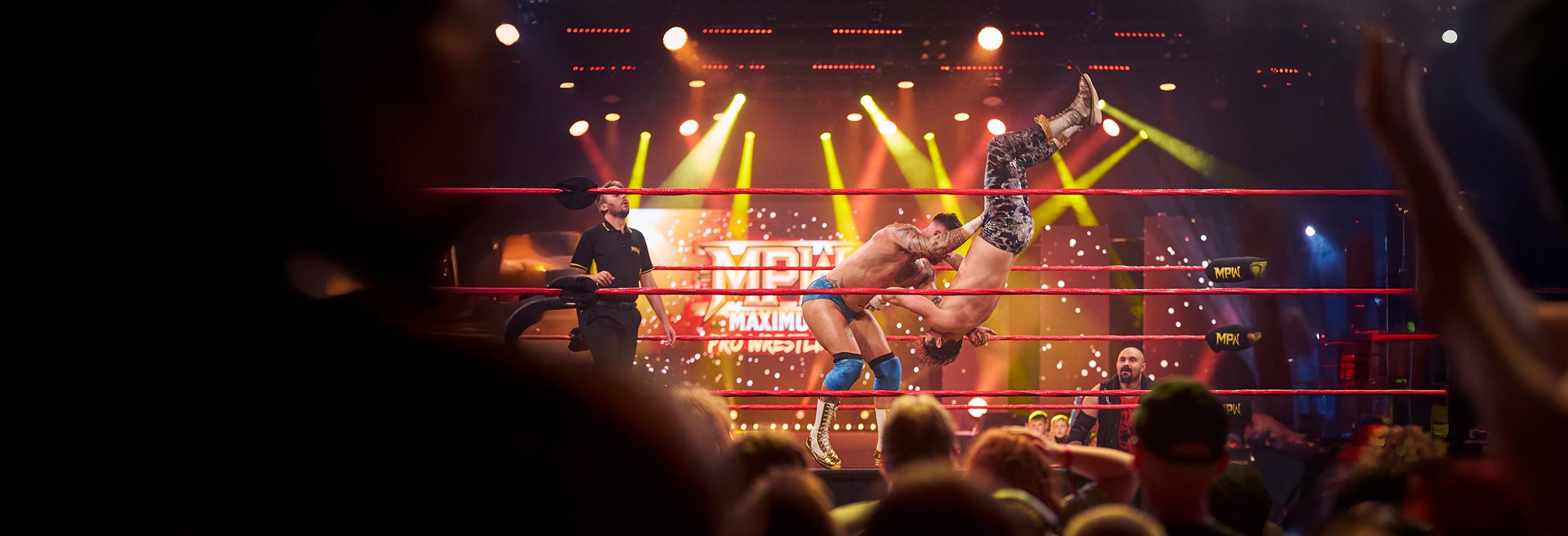 Two wrestlers fight in the centre of the ring for a Maximum Pro Wrestling live show at Butlin's.