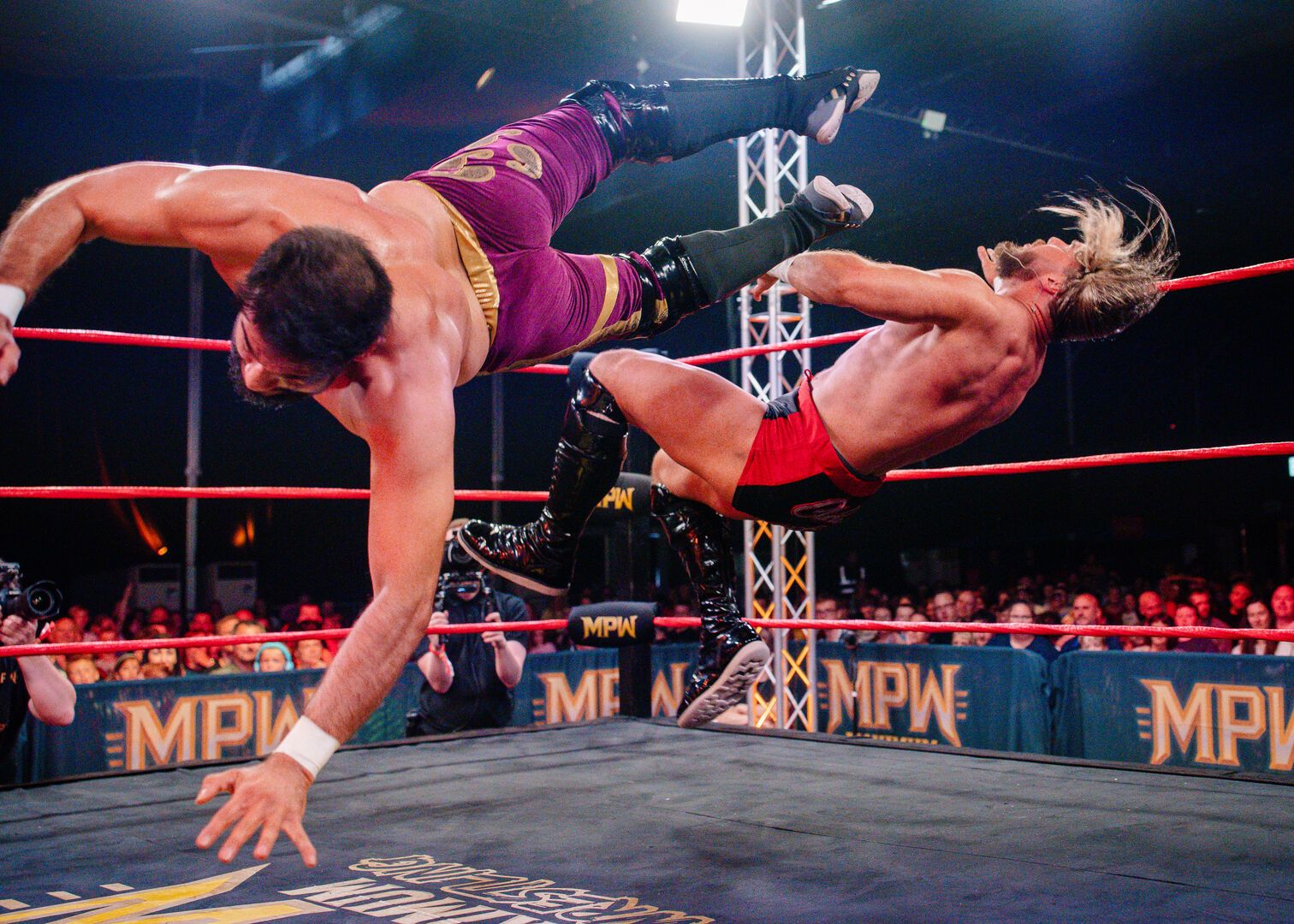 Two wrestlers fight in the ring during a Maximum Pro Wrestling show.